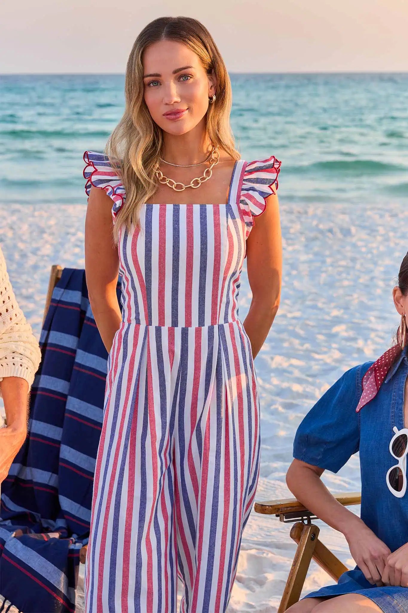 woman wearing multi stripe jumpsuit on beach