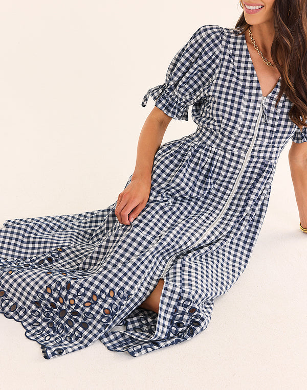 lifestyle navy dress on woman with white background na