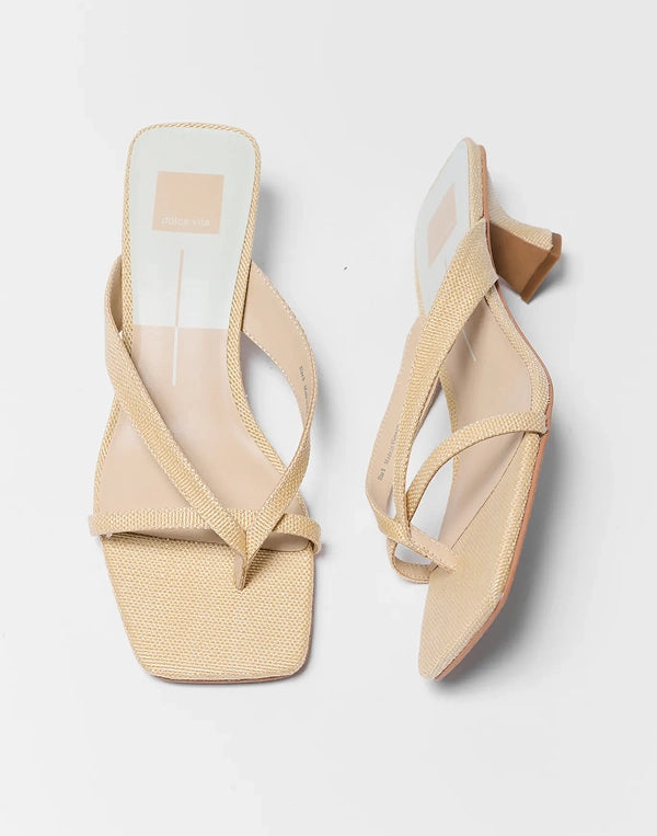 Beige sandals with clear straps on a light gray background navigation