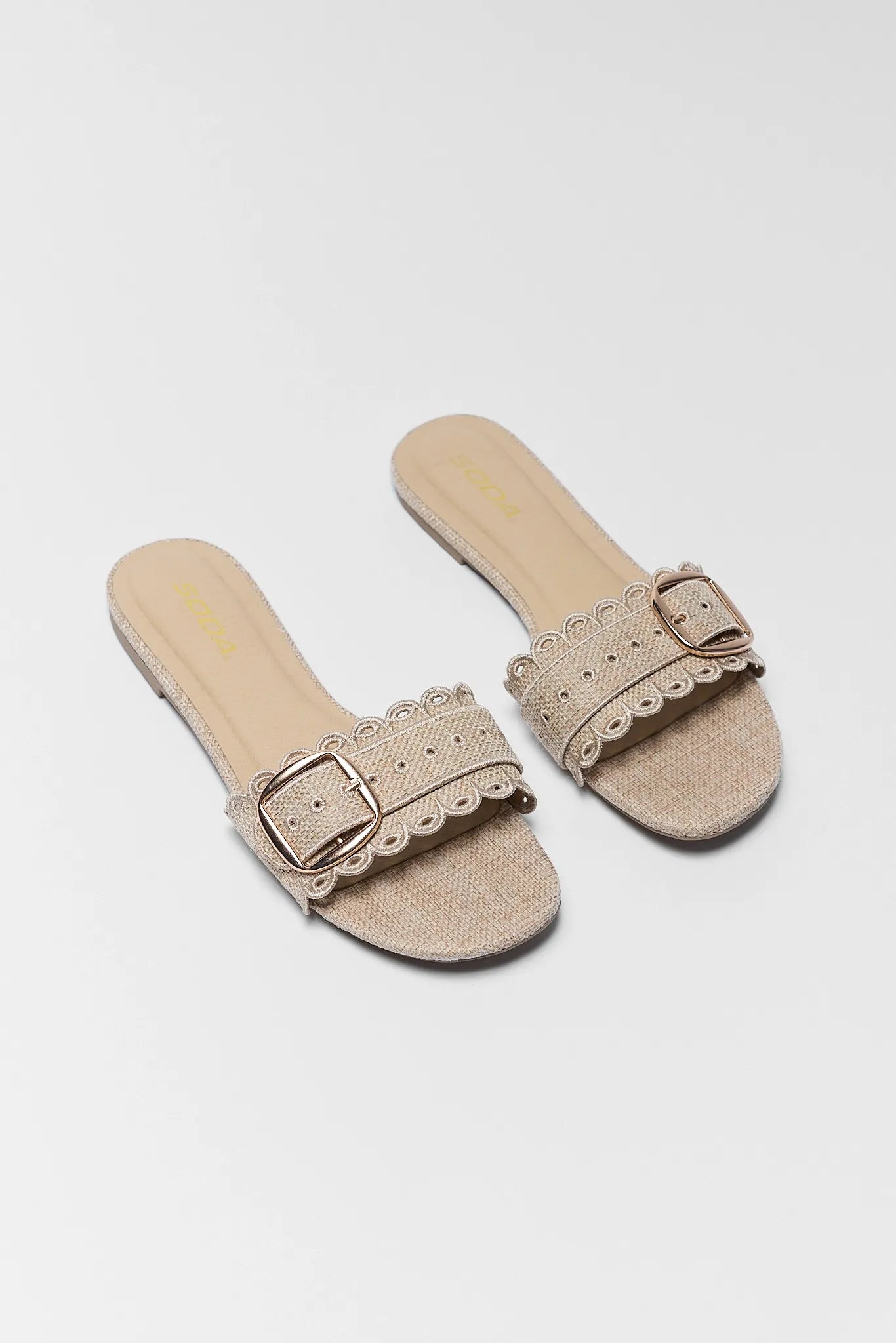 Nancy Tan Scalloped Buckle Sandals on grey background