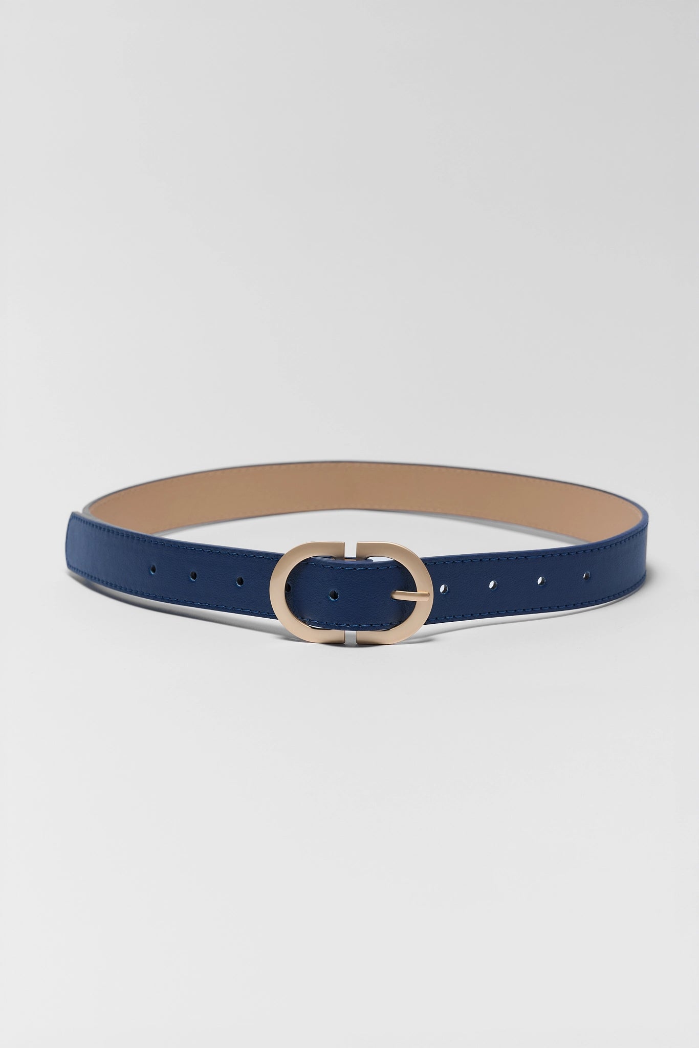 Blue belt with a gold buckle on a light gray background
