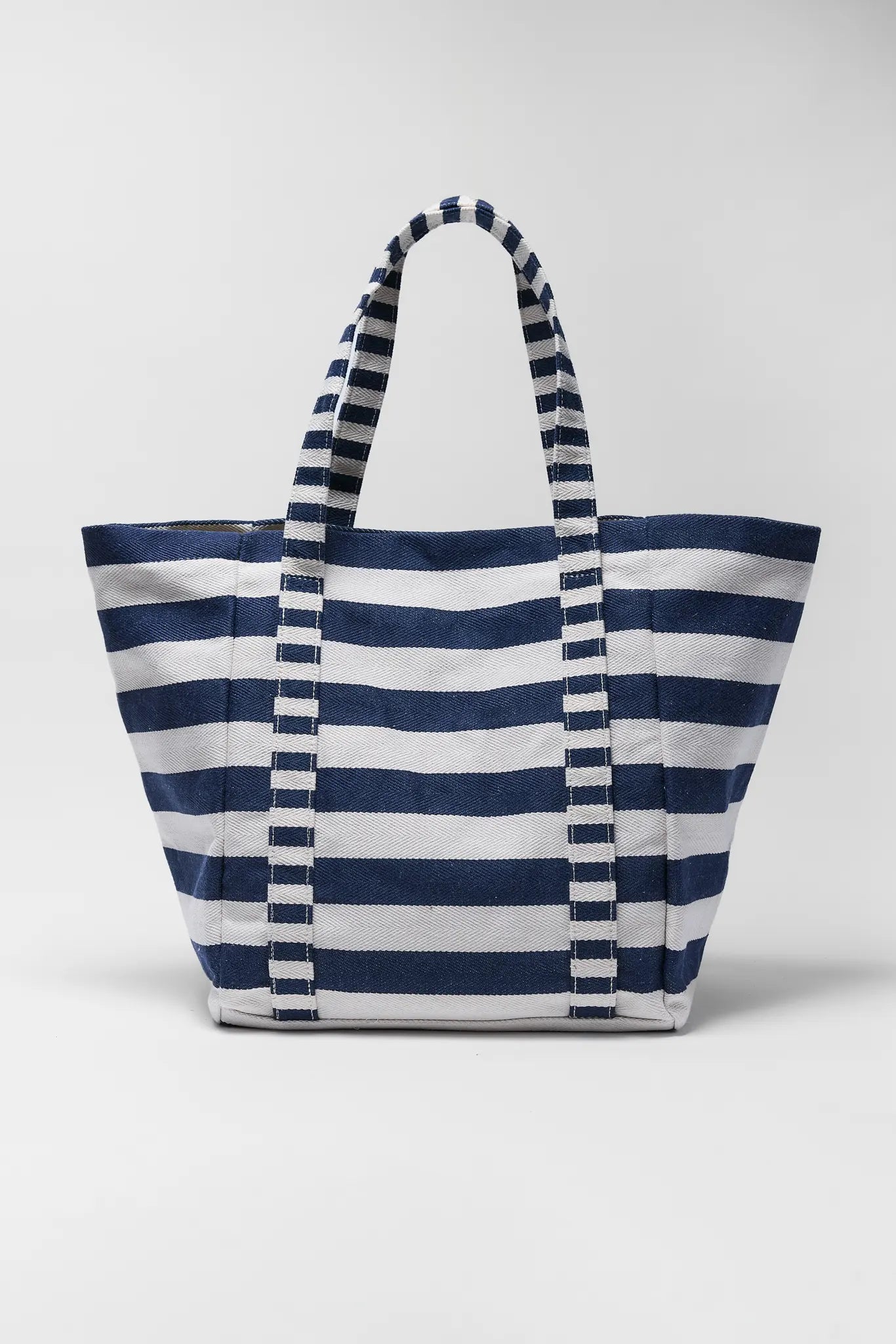 Navy and white striped tote bag on a light gray background
