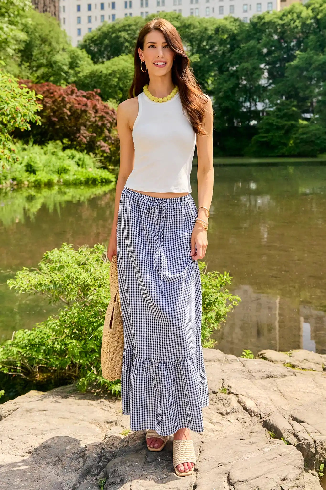 Woman wearing a black and white checkered skirt outdoors in park