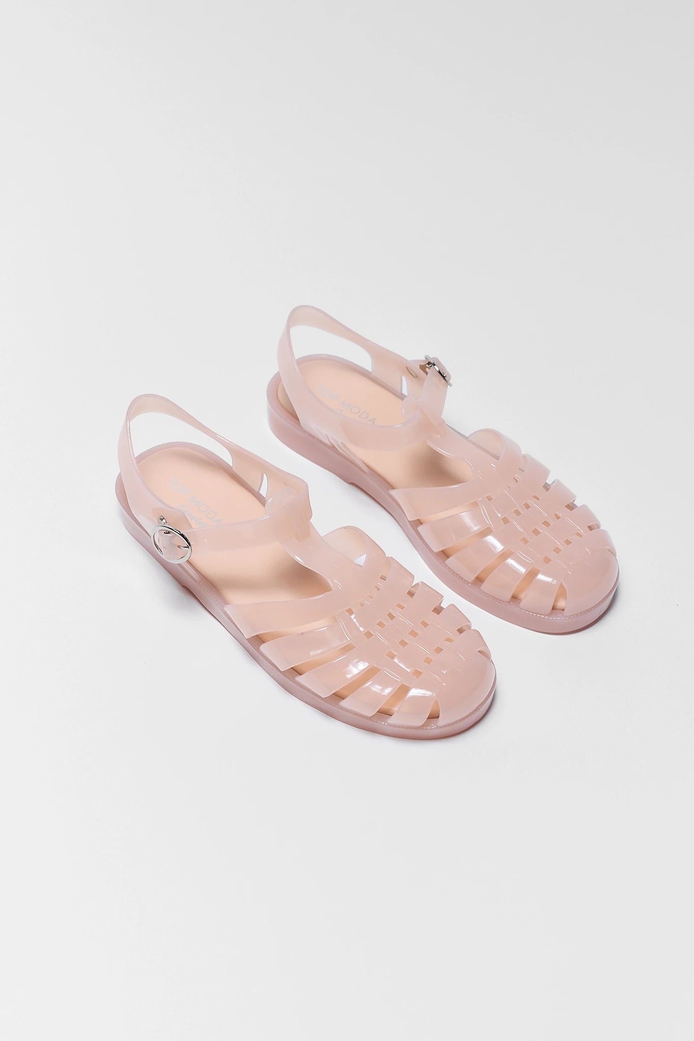 two Pair of pink jelly sandals on a white background