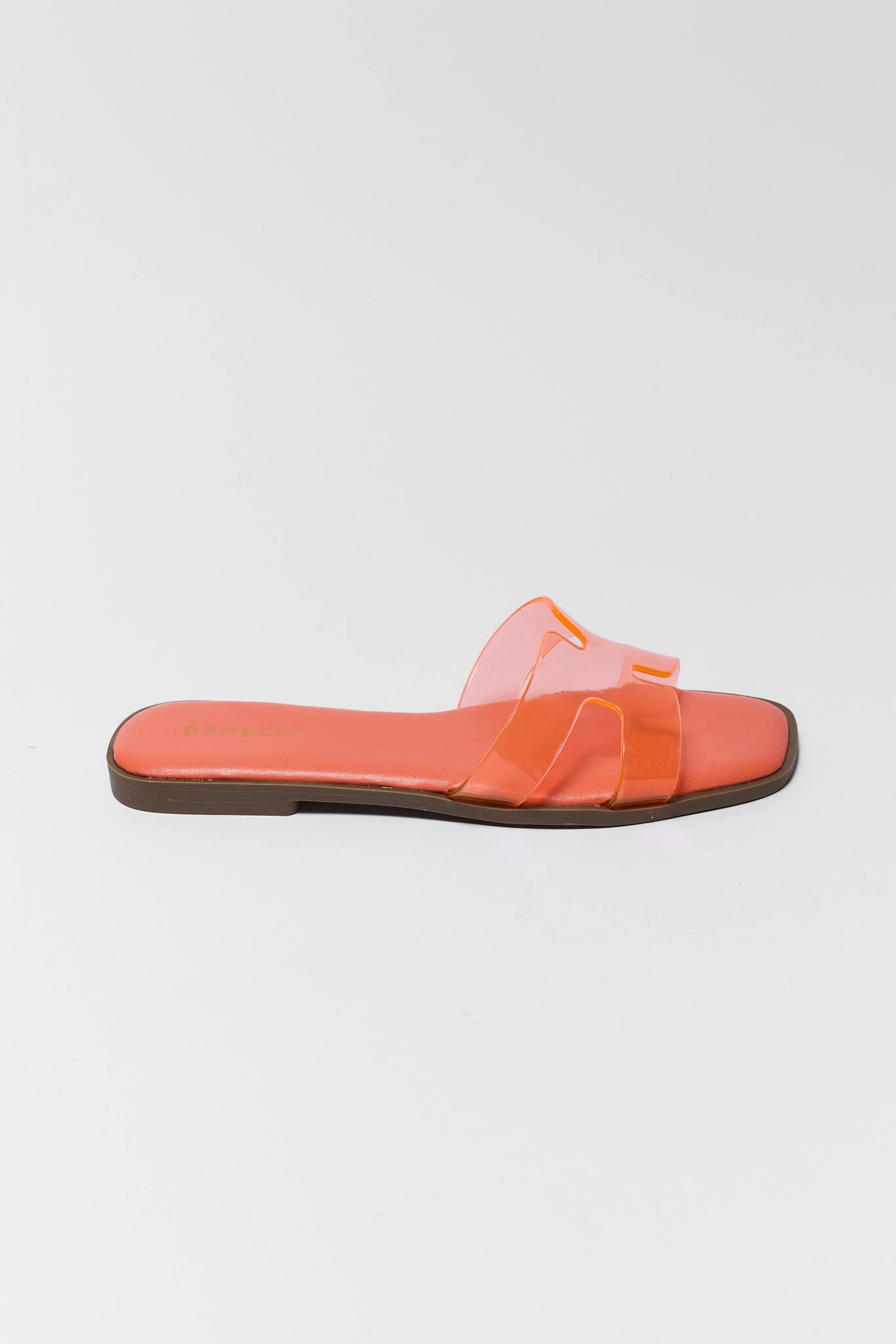 one Orange slide sandal with transparent strap on a light gray background