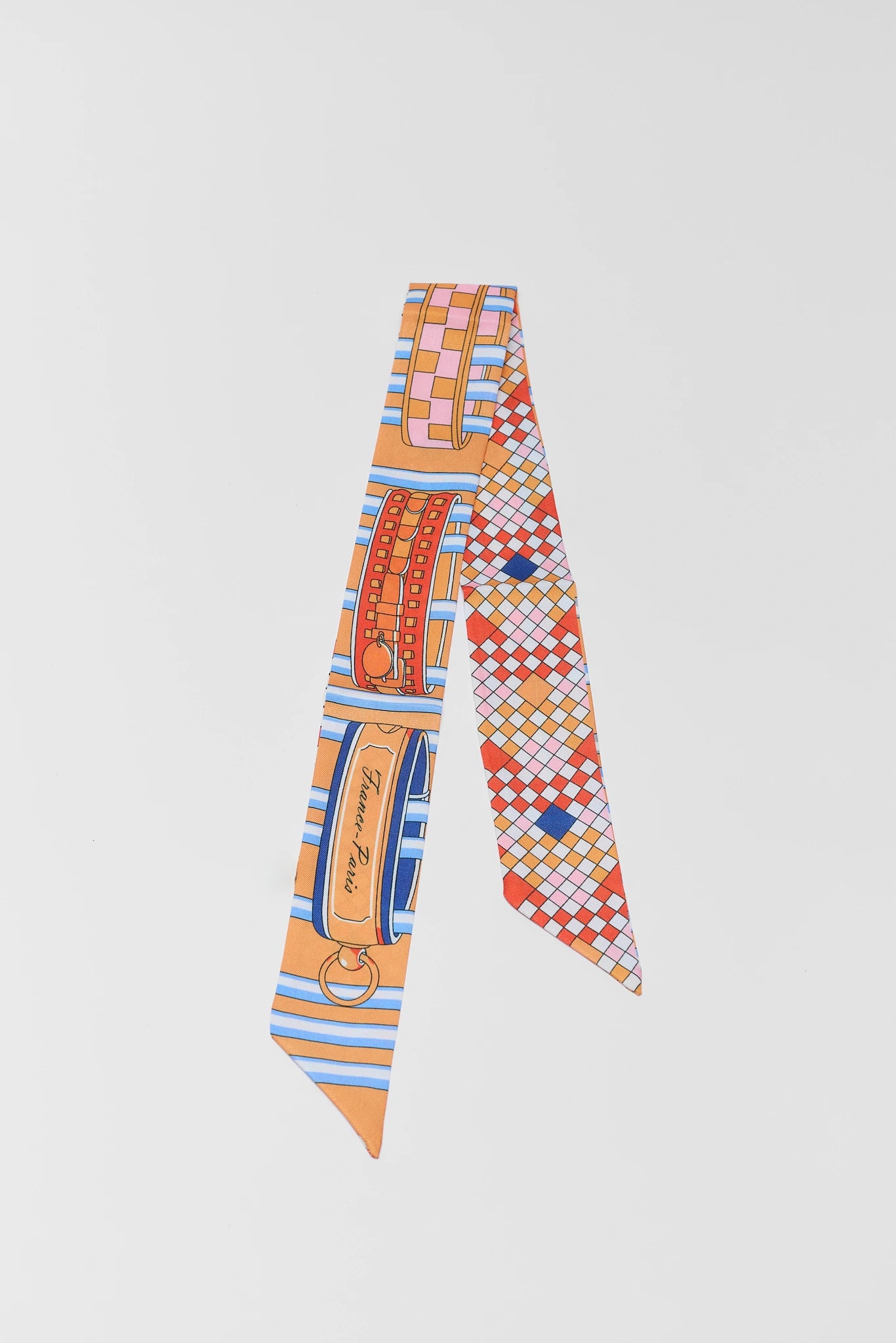 Colorful patterned scarf with a brand logo on a light gray background