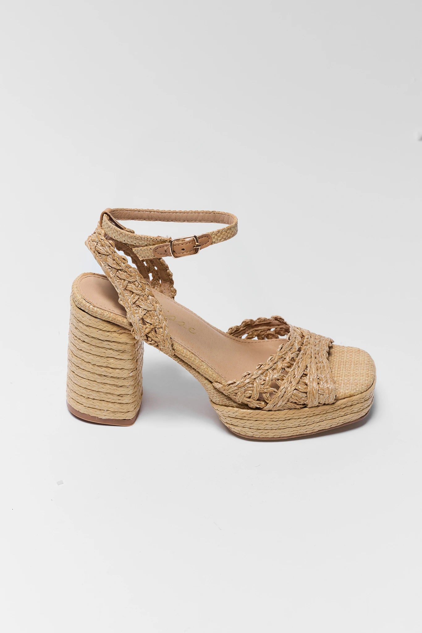Beige woven sandal with a block heel on a white background