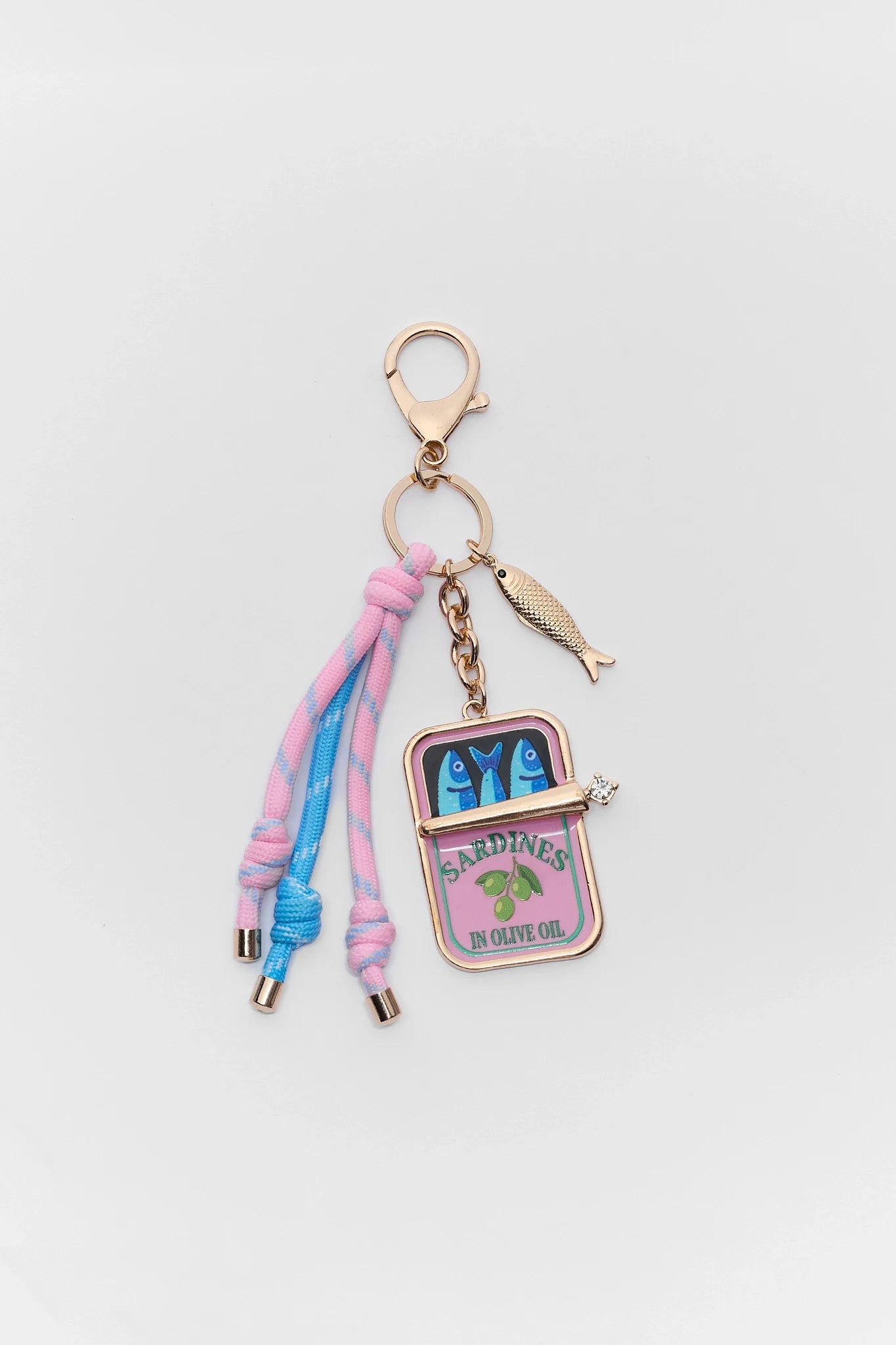 Keychain with colorful tassels and a small pouch charm on a light gray background