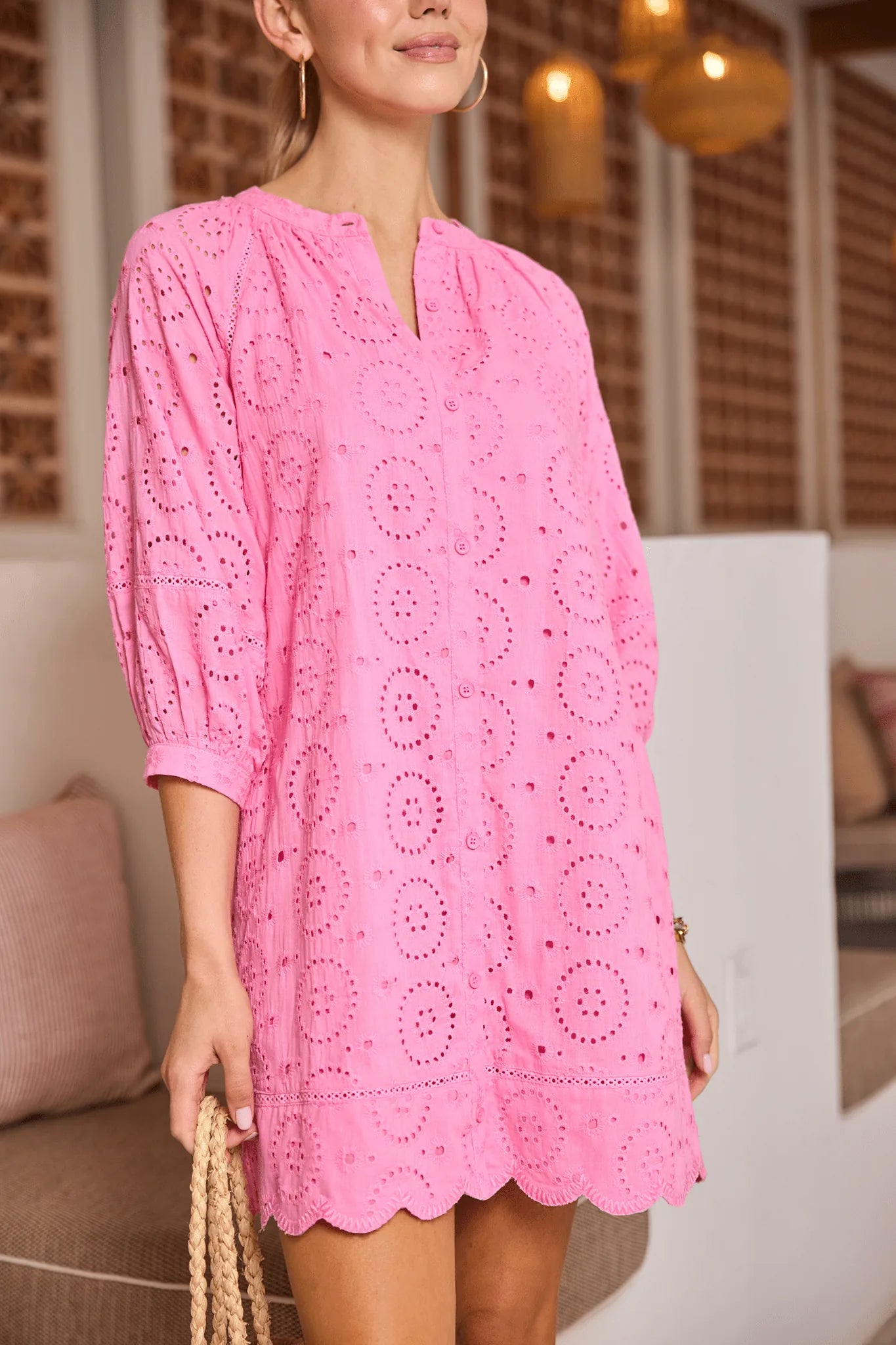 close up Woman wearing a pink lace dress in an indoor setting