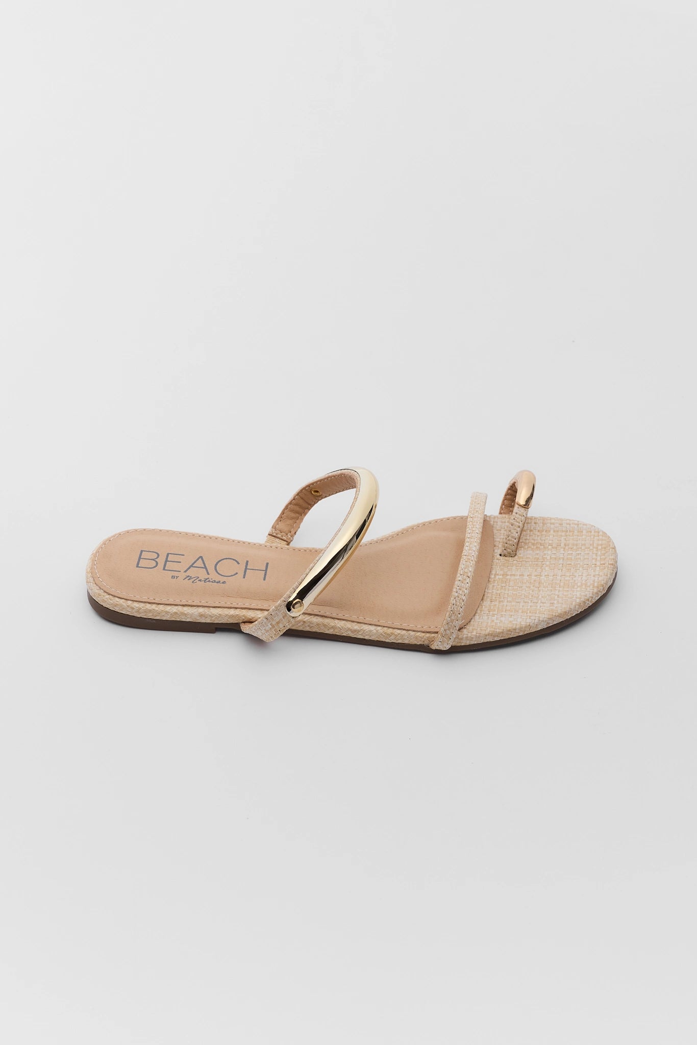 one Beige sandal with  branding on a light gray background