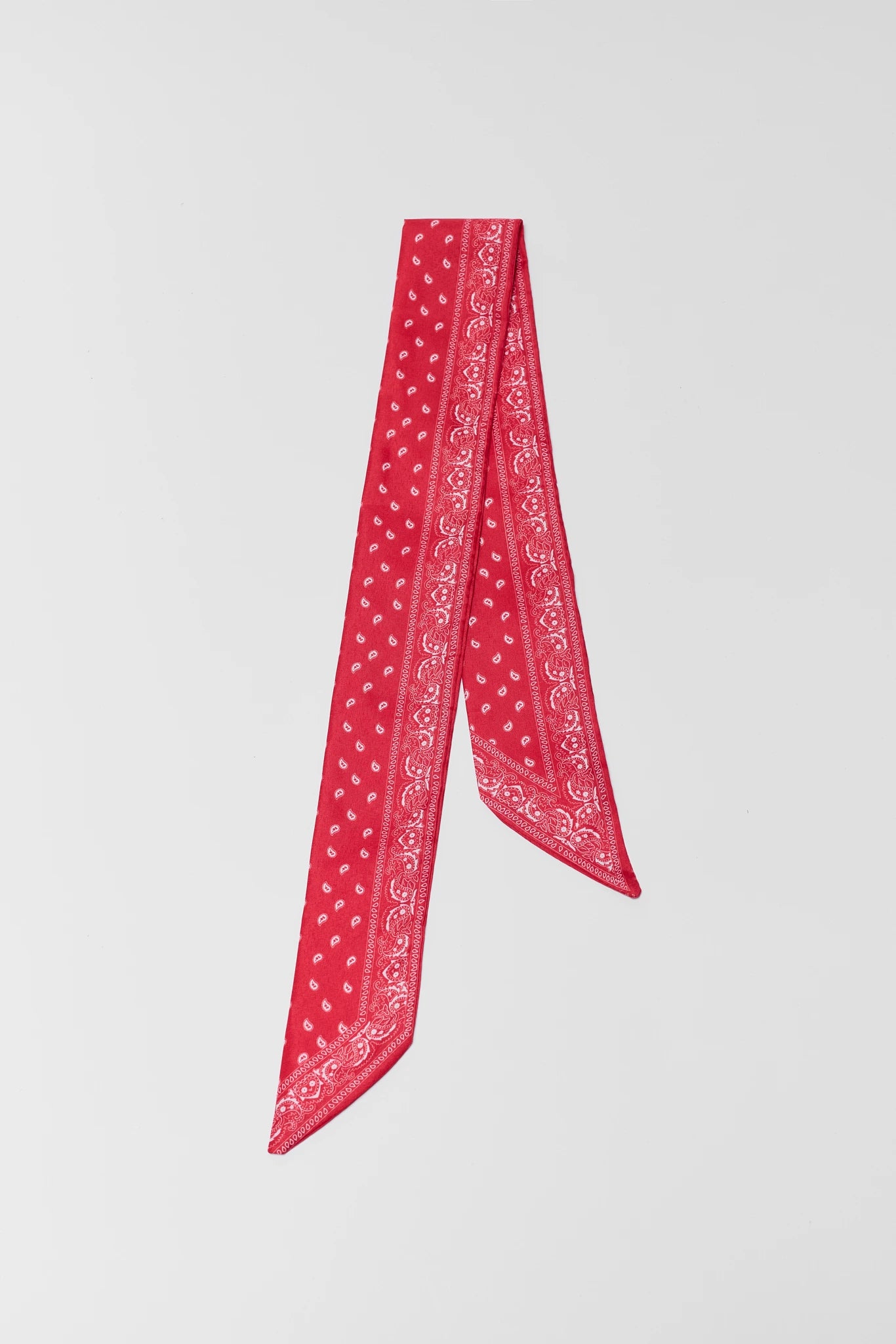 Red patterned scarf on a light gray background