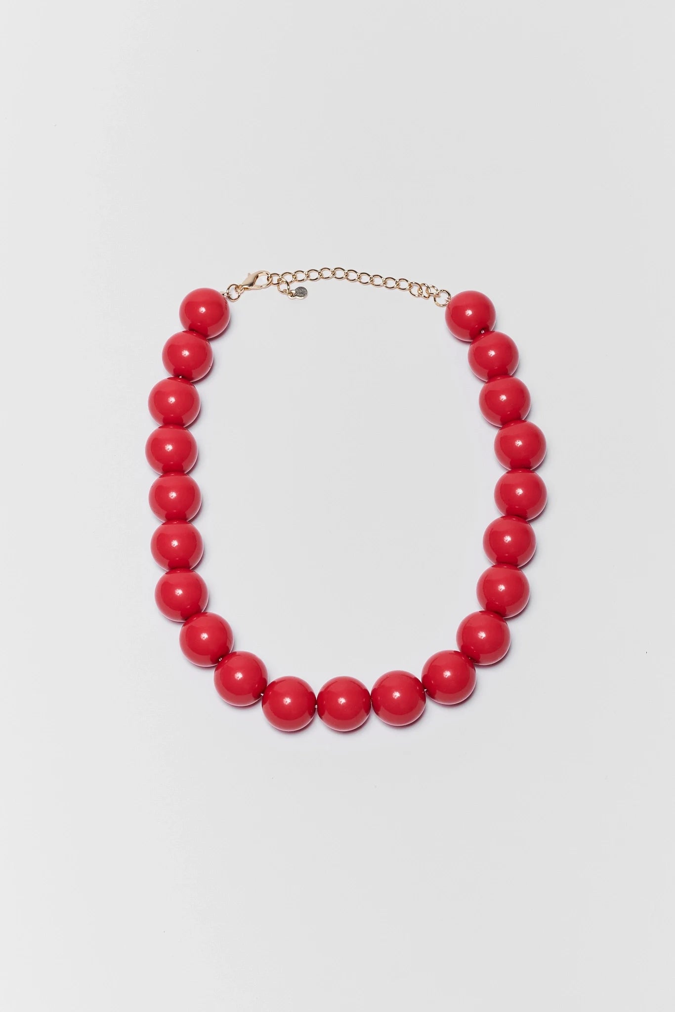 Red beaded necklace on a light gray background