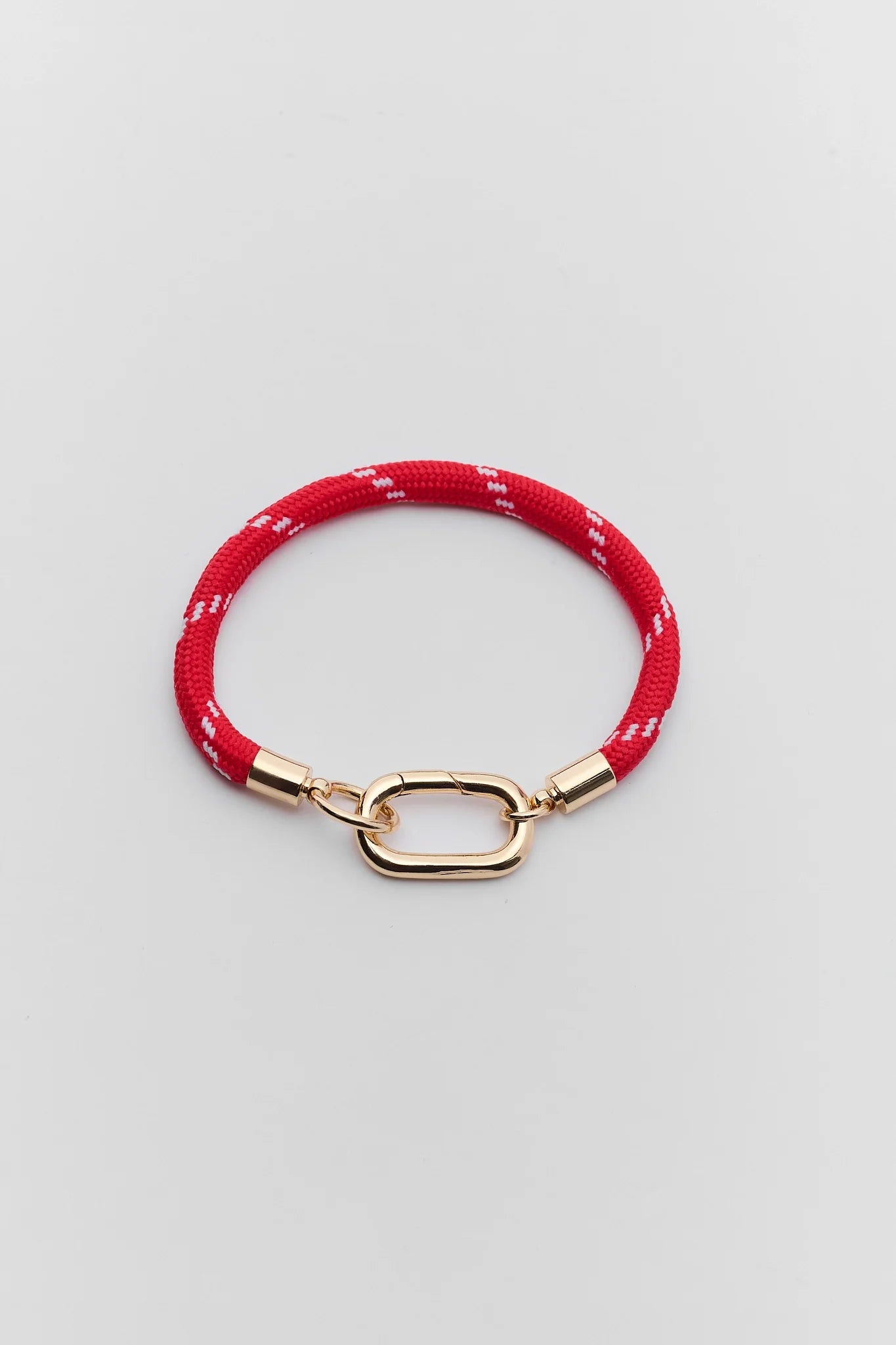 A red woven rope bracelet with a gold-tone lobster clasp, displayed on a neutral light gray background.