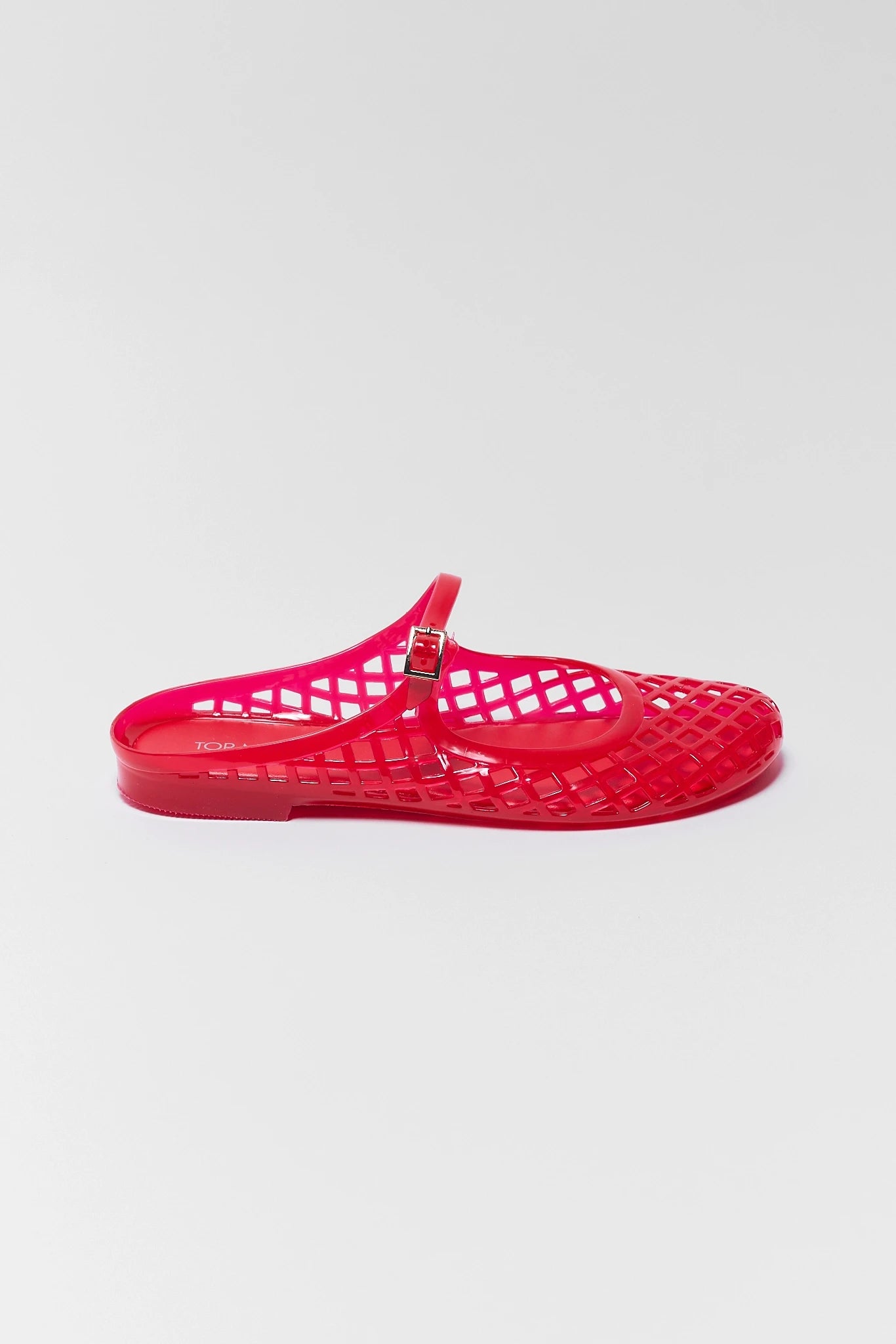 one Red jelly sandal on a light gray background