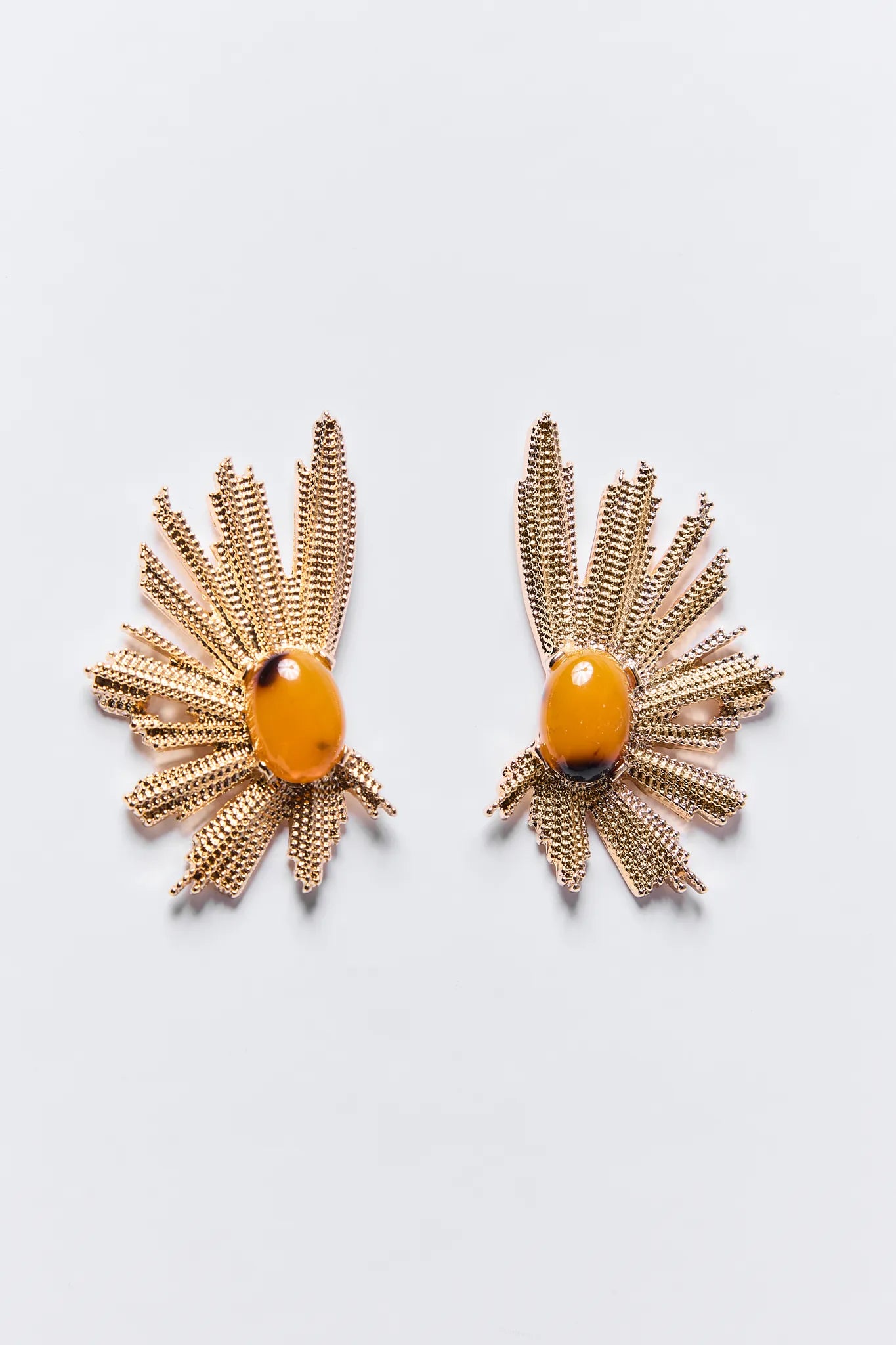 Gold Reina Earrings with orange beads on a light gray background
