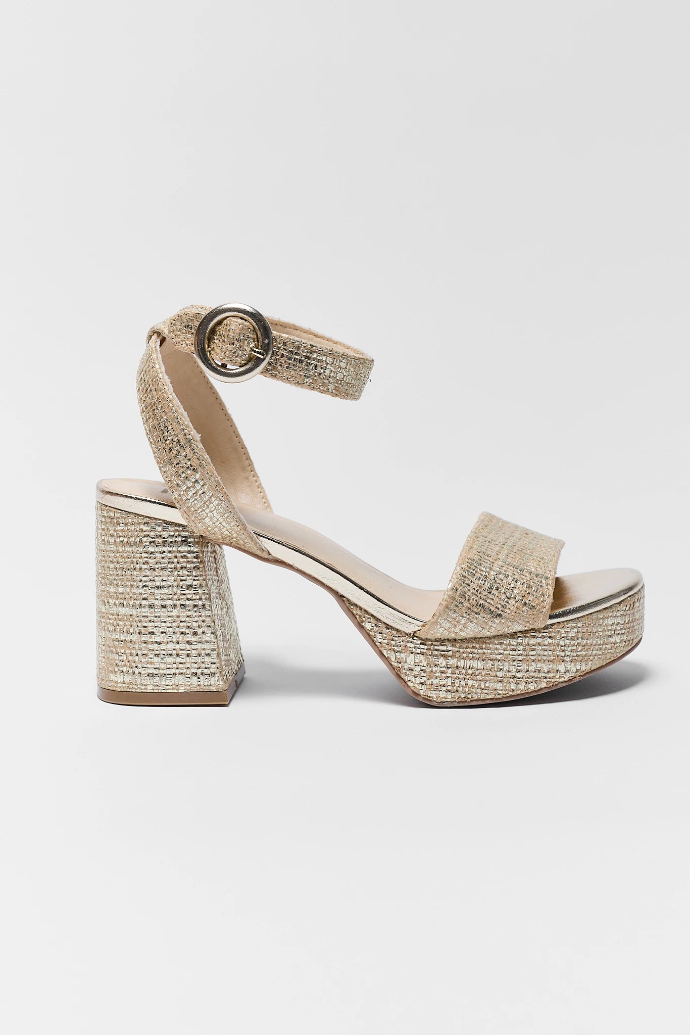 one Gold glittery sandal with a block heel on a light gray background