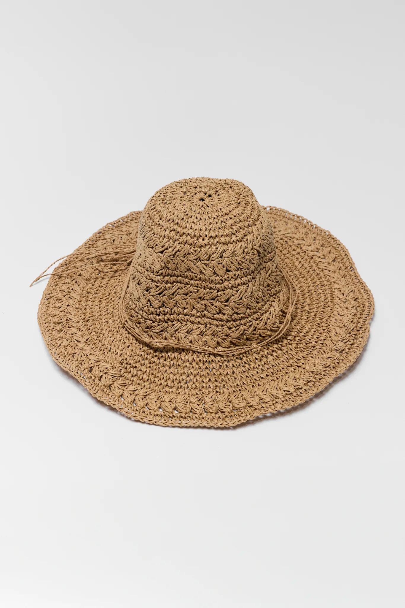 Brown crochet sun hat on a light gray background