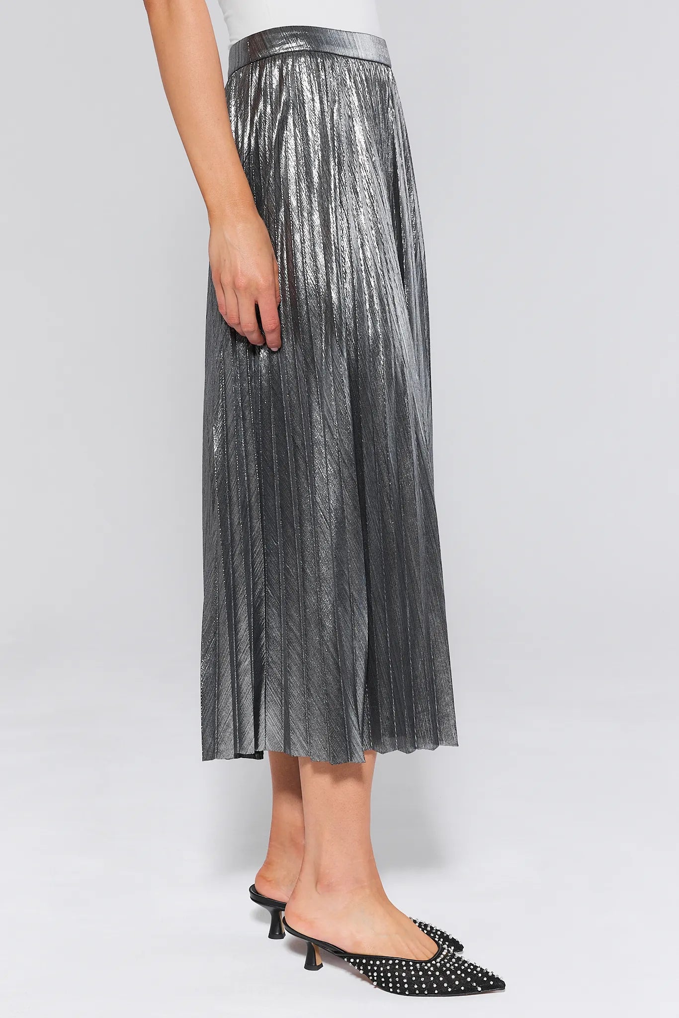 Person wearing a Hensley Silver Pleated Midi Skirt on a white background