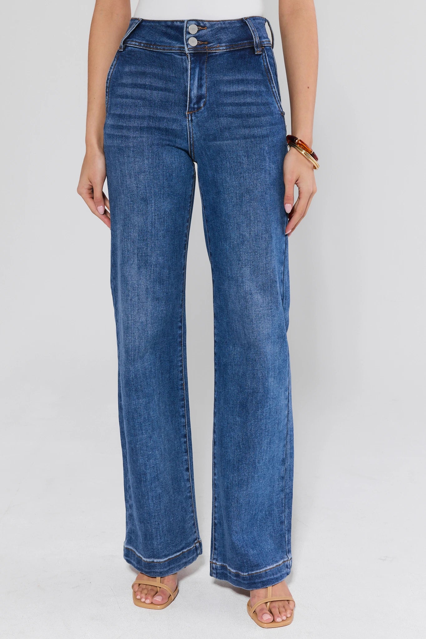 Person wearing blue jeans on a white background