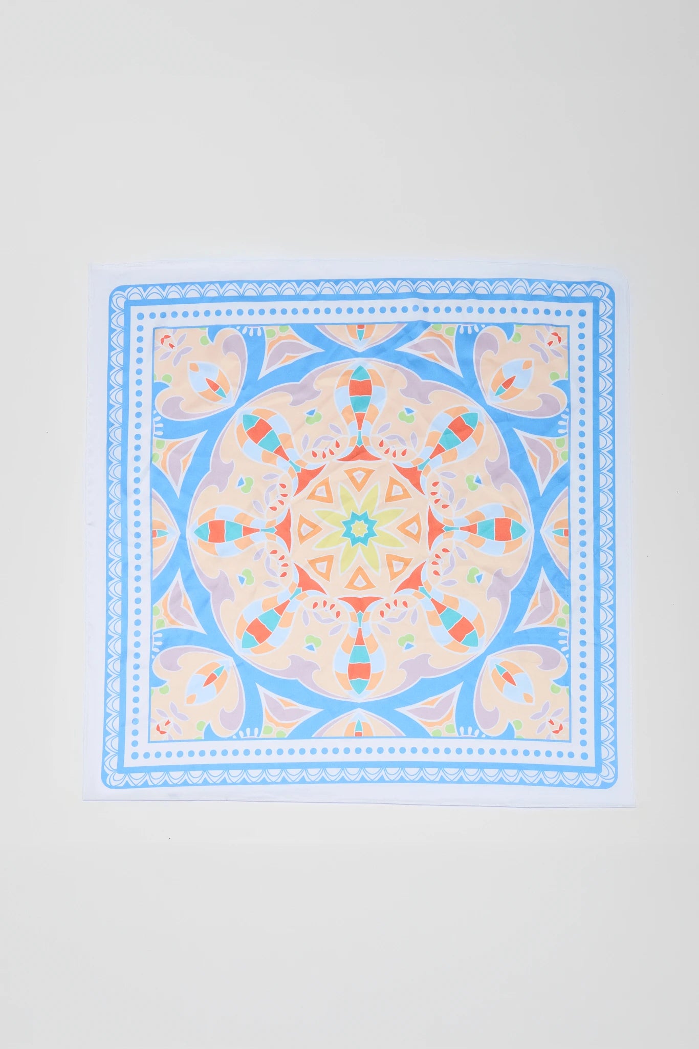 Colorful mandala patterned bandana on a light gray background