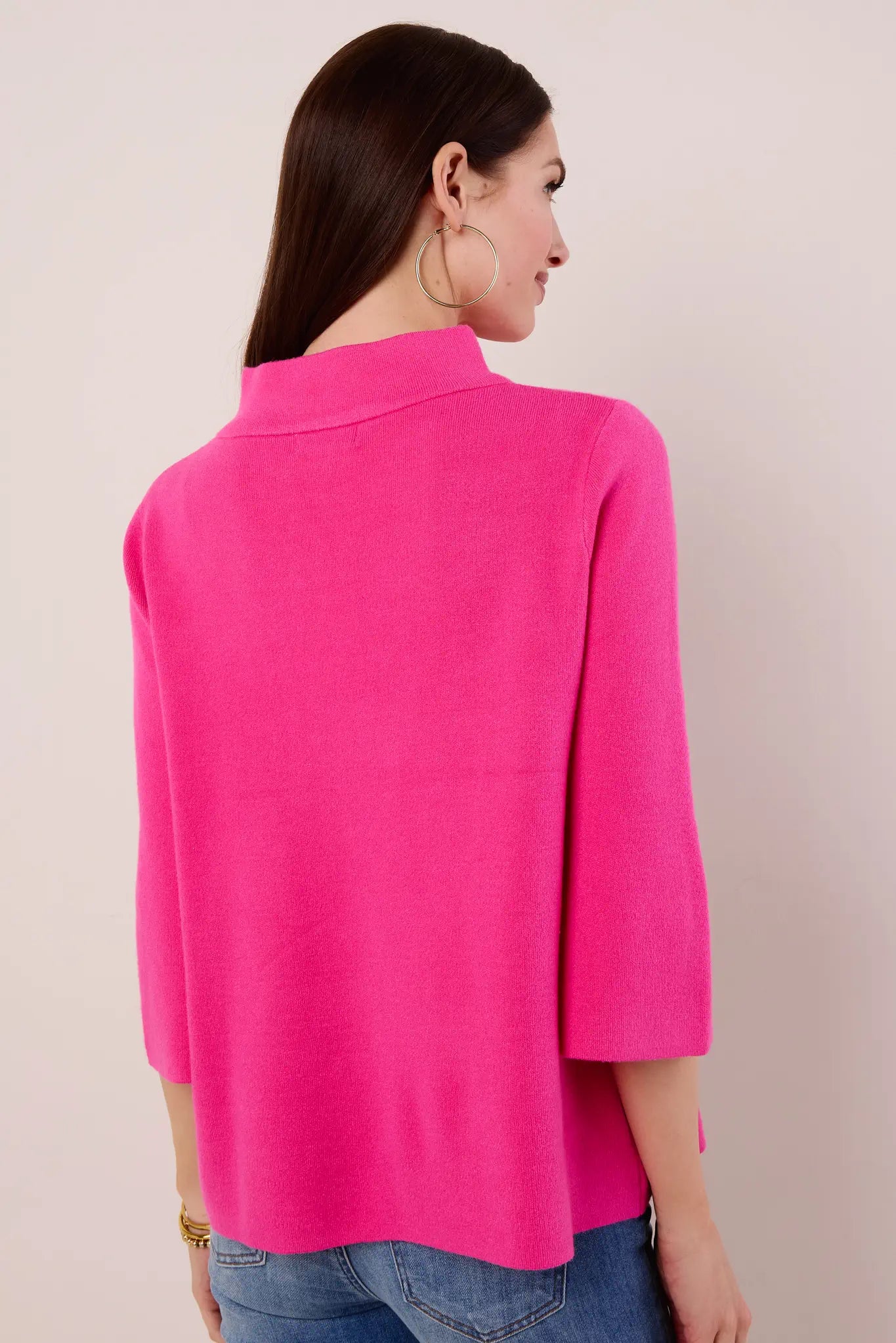 Person wearing a bright pink Jackie Sweaer against a plain background