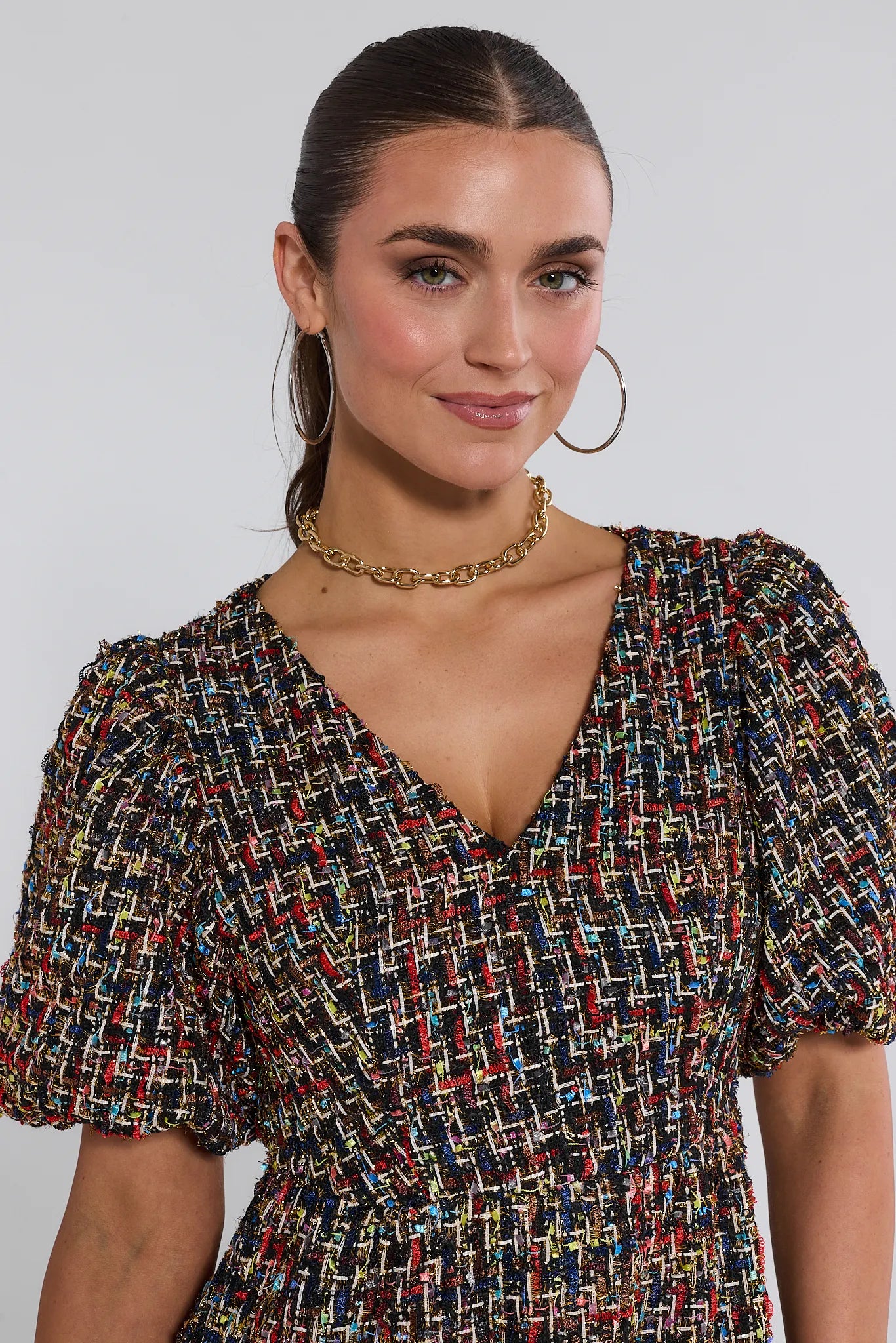 Woman wearing a patterned Cindy Multi Tweed Mini Dress against a plain background