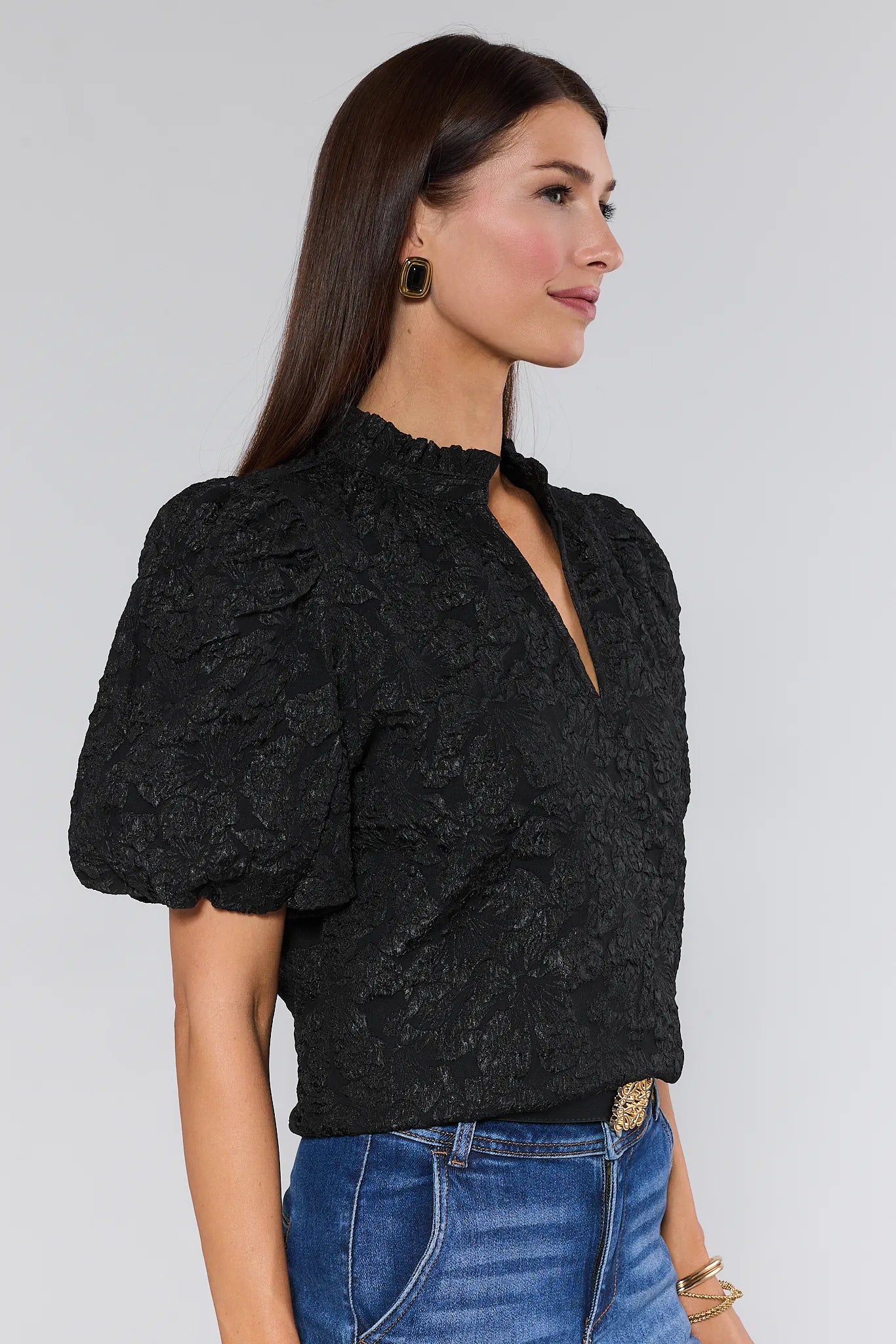 Woman wearing a Teresa Black Floral Top with puffed sleeves against a white background