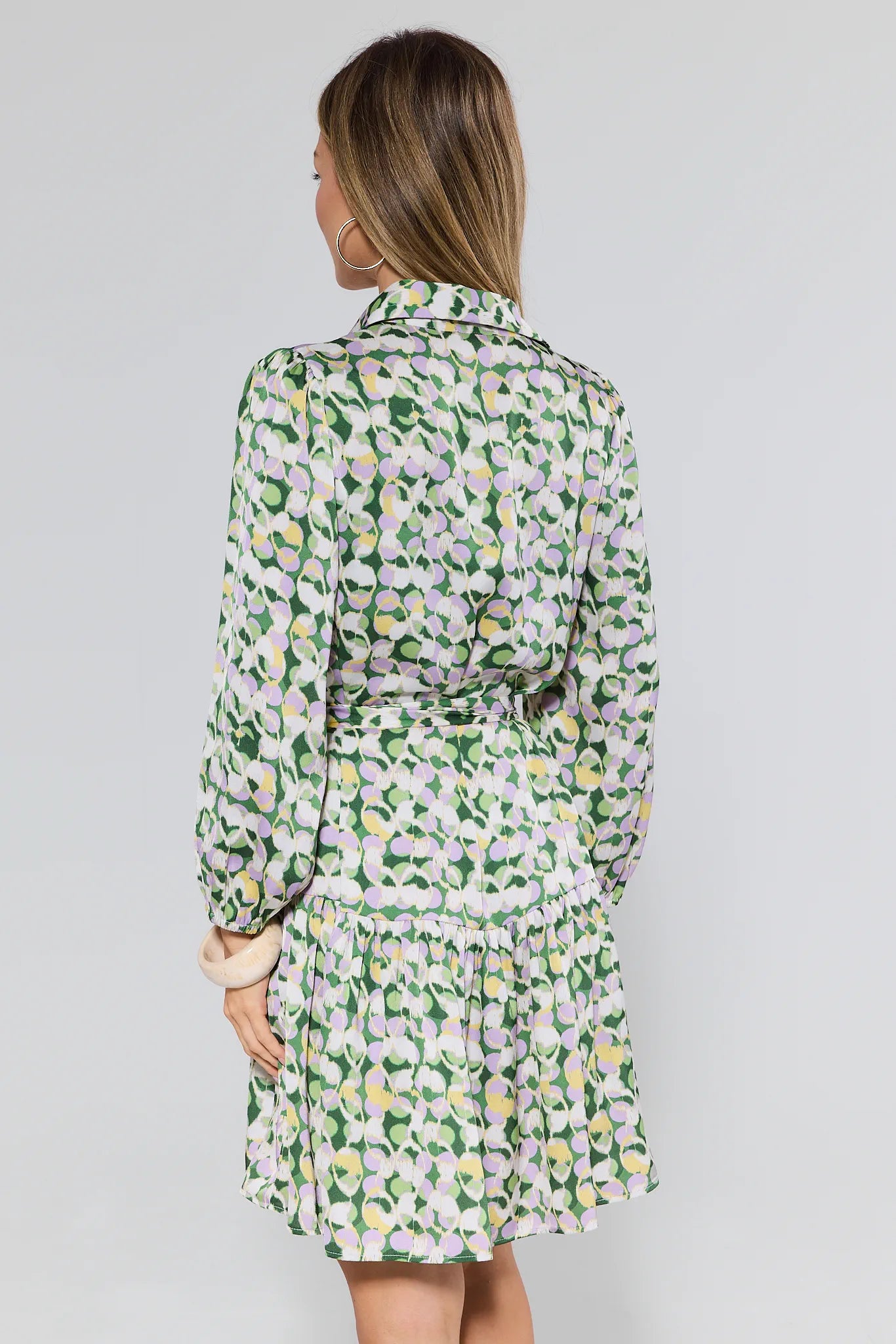 Woman wearing a floral dress with a plain background