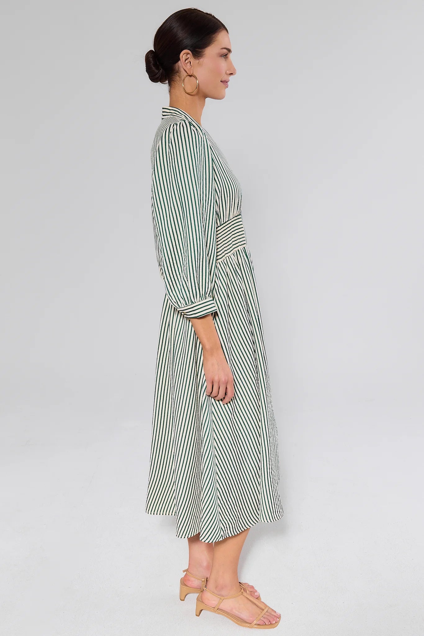 side shot woman wearing green brantley dress on white background