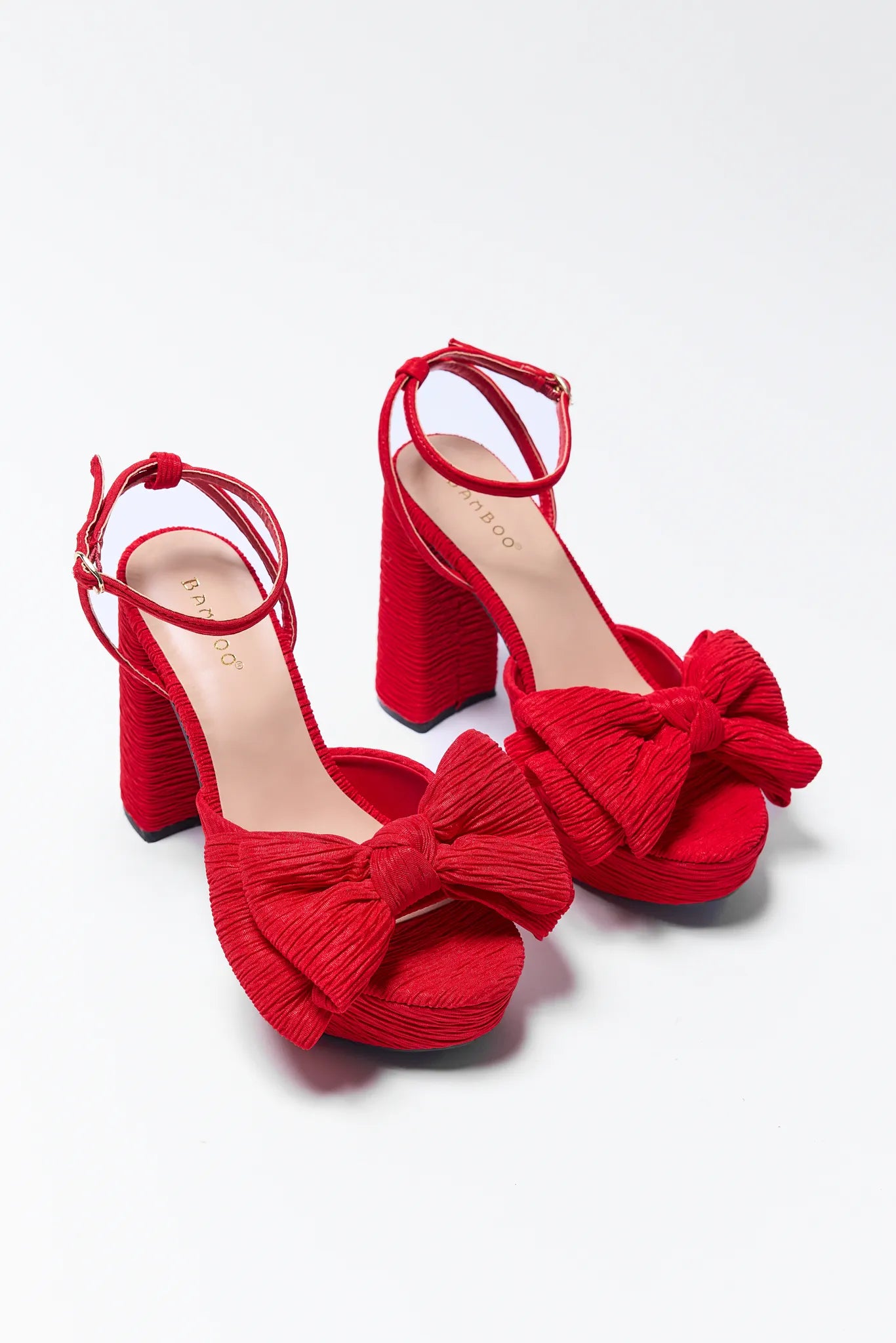 Nicole Red Platform Heels with bow details on a white background