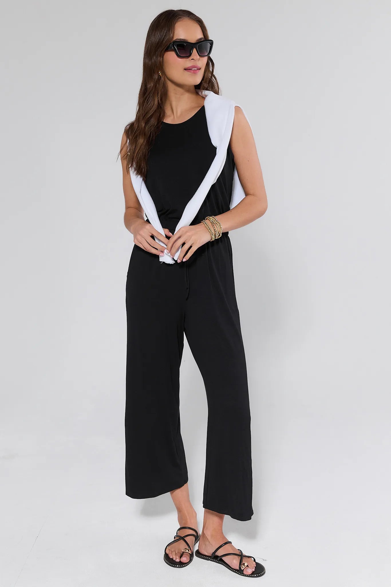 Woman wearing a black and white outfit on a plain background