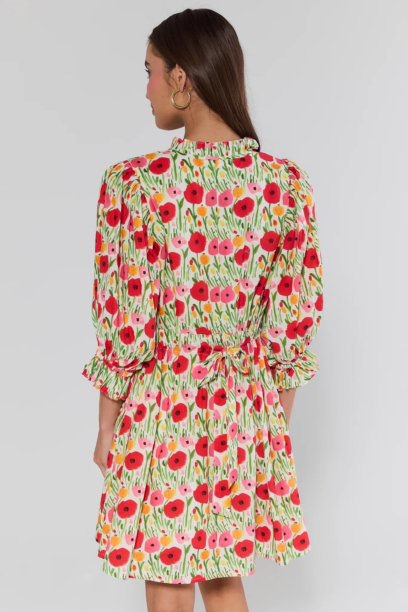 Woman wearing a floral dress with a white background