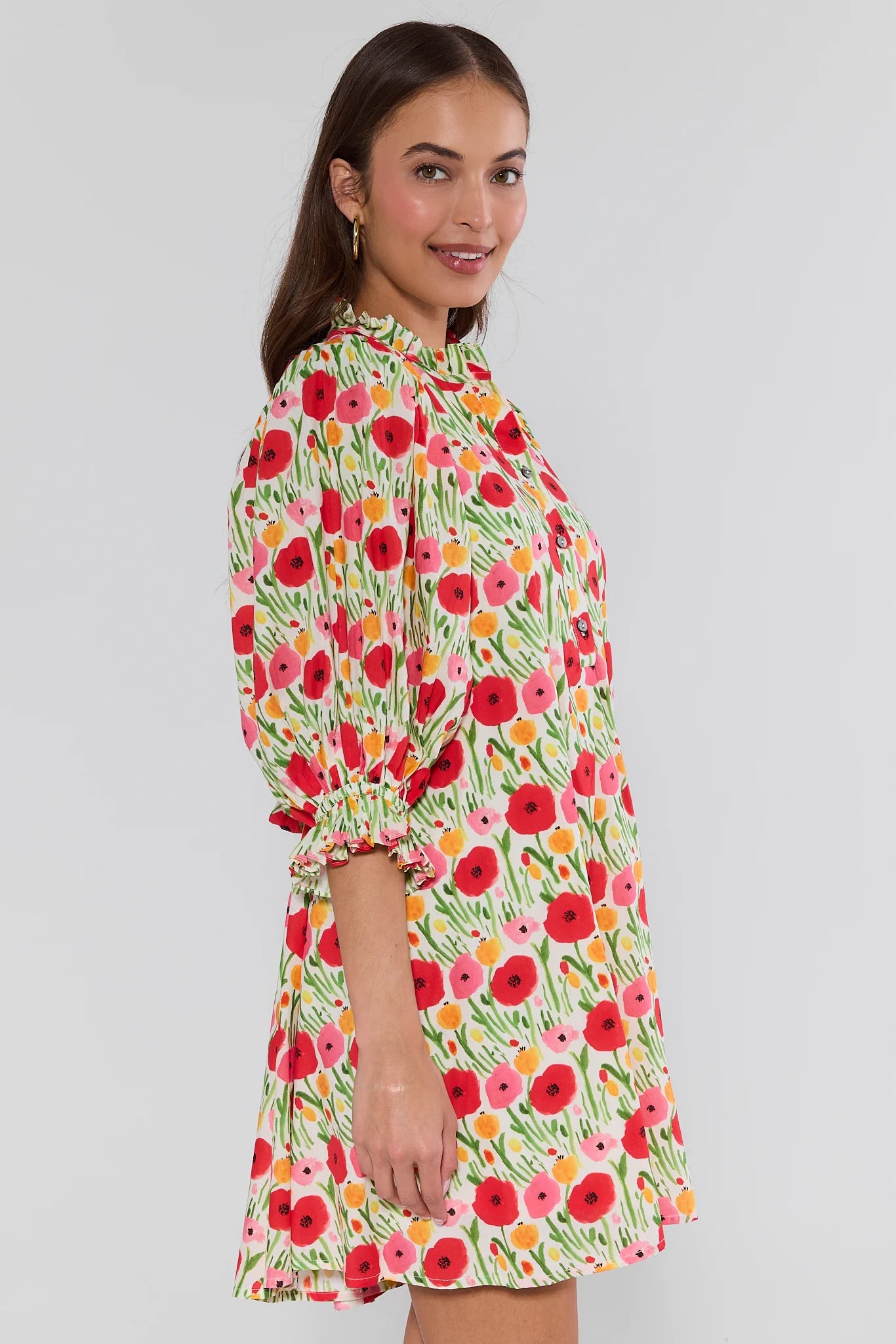 Woman wearing a floral dress on a plain background