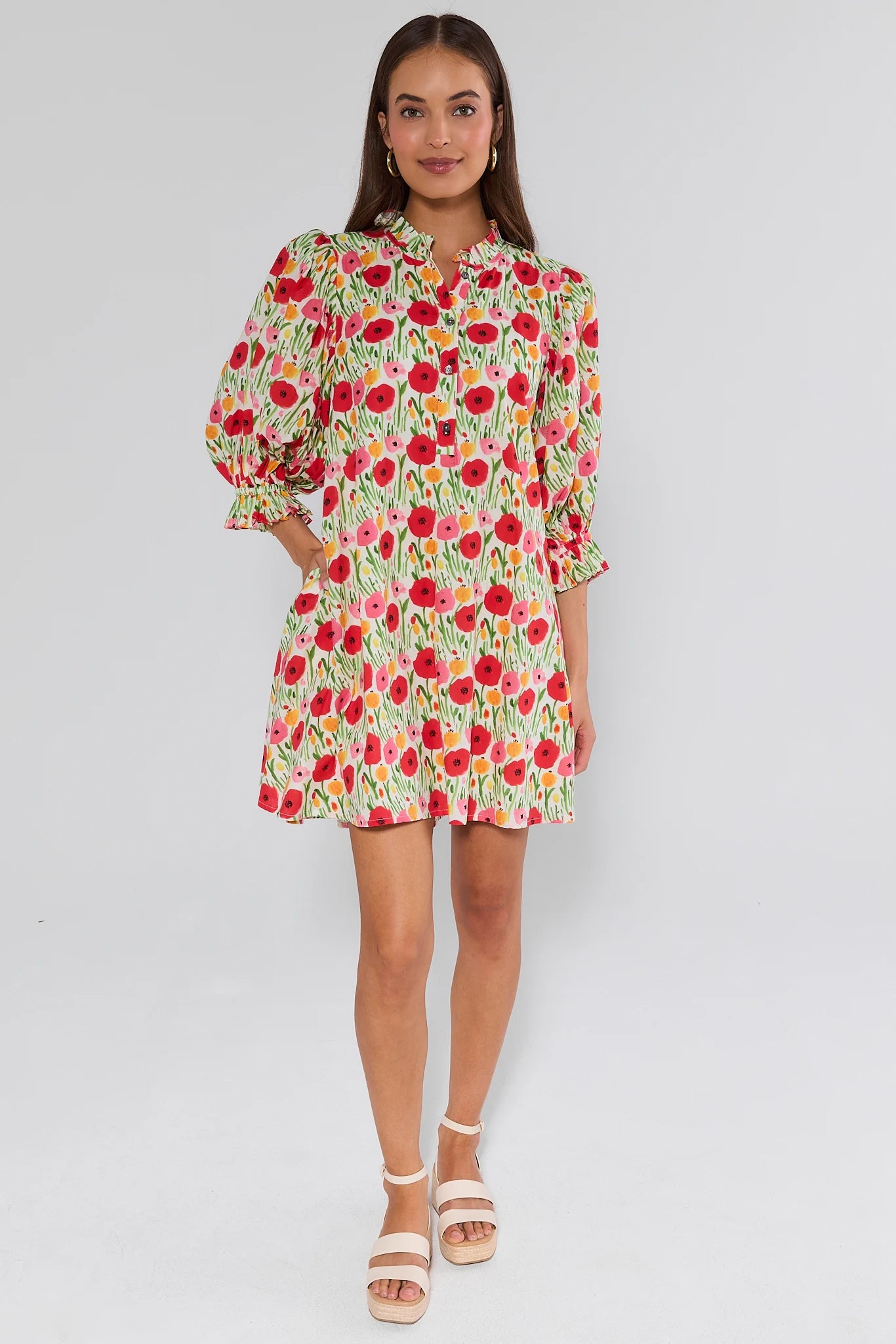 Woman wearing a floral dress on a plain background