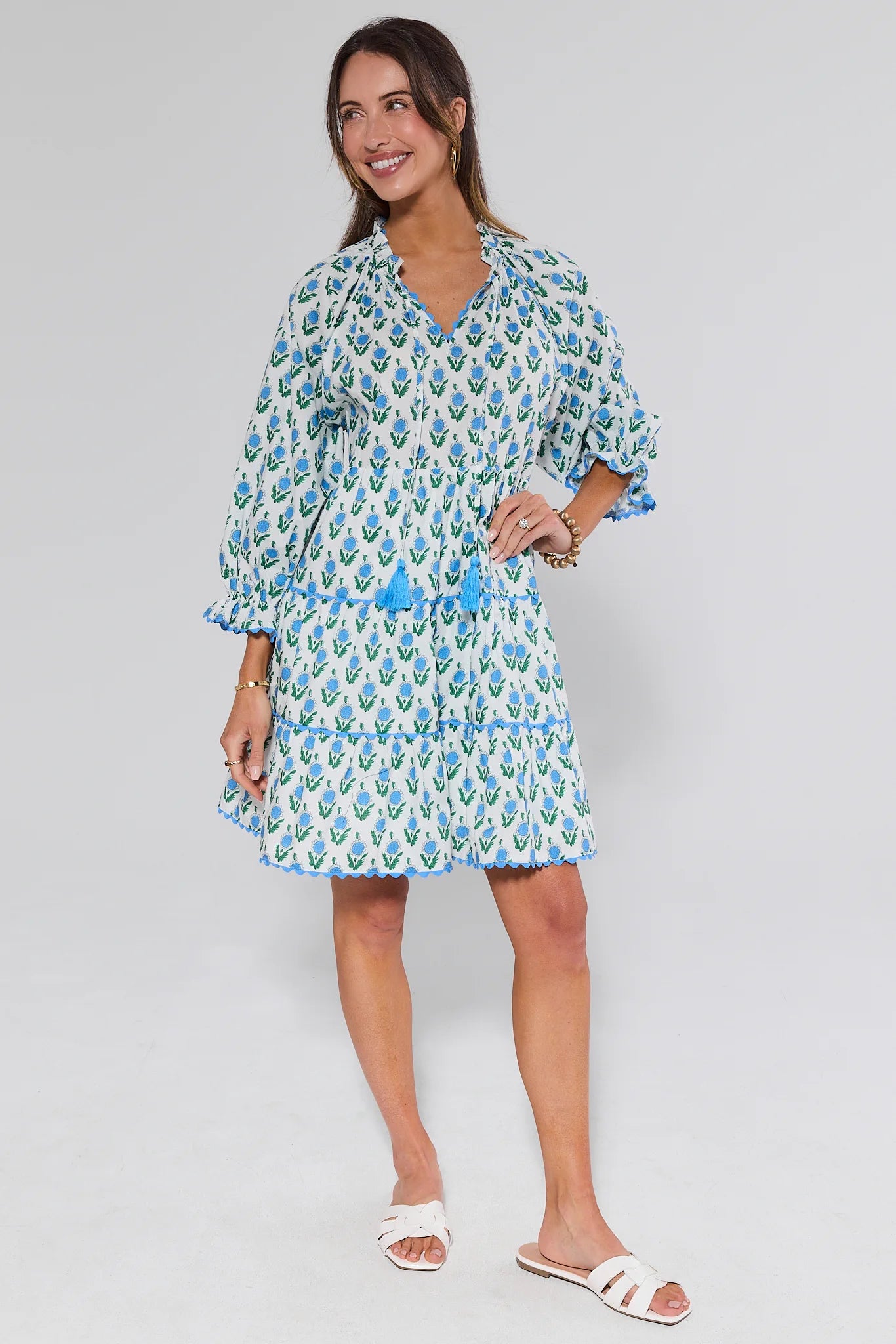 Woman wearing a floral dress on a plain background