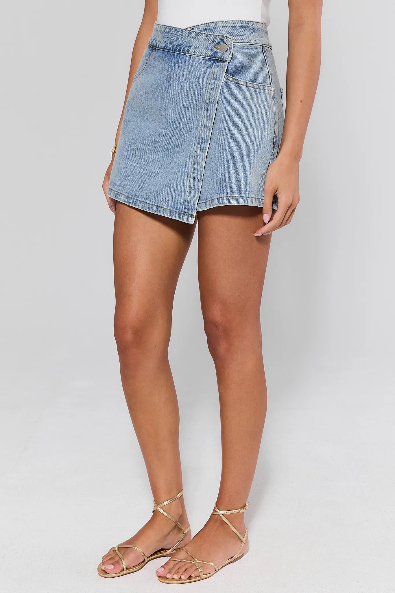 side shot Denim skirt worn by a person on a plain background
