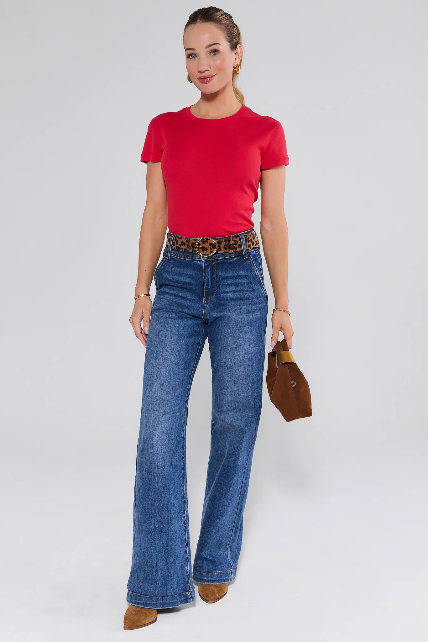 Woman wearing a Aria Tee- Red and leopard print belt on a plain background