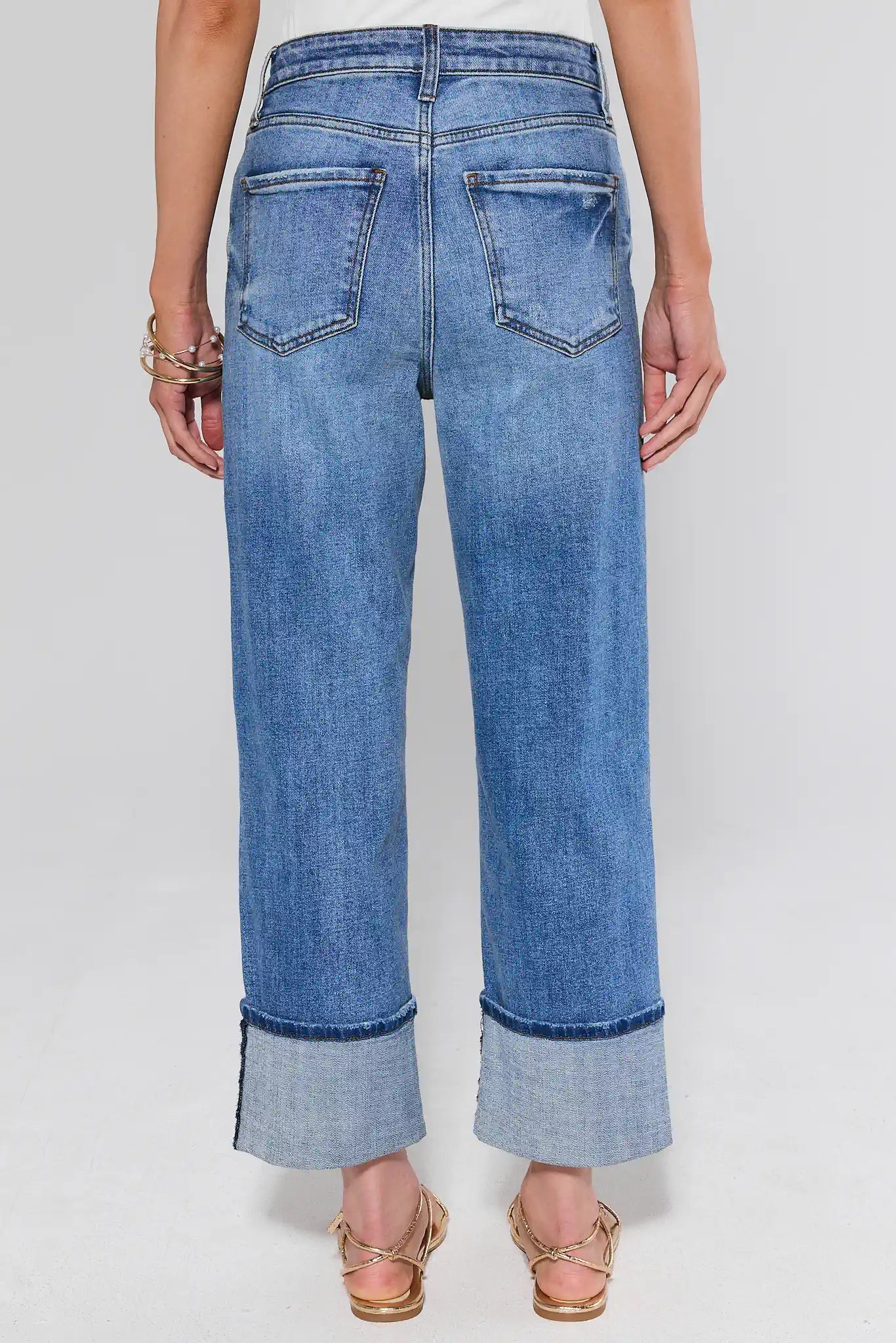 Blue jeans with cuffs on a white background
