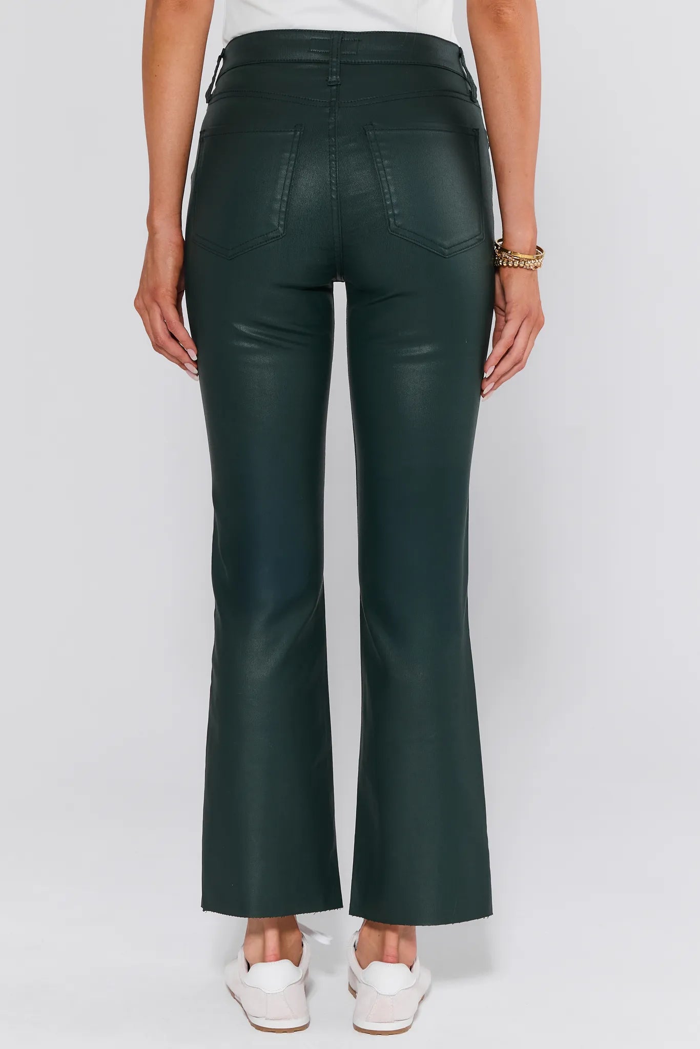Green leather Kelsey Jeans Wax Coated worn by a person on a white background