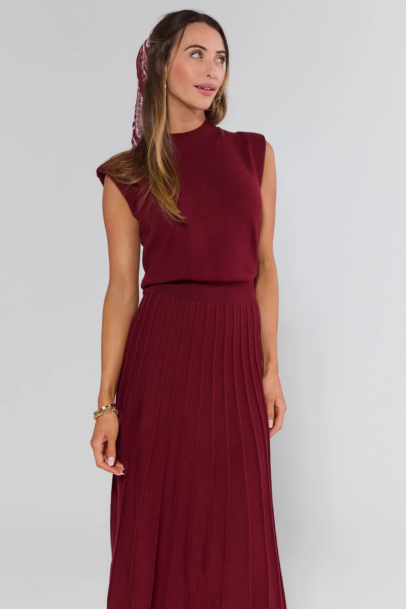 Woman wearing a burgundy Josie Dress with a plain background