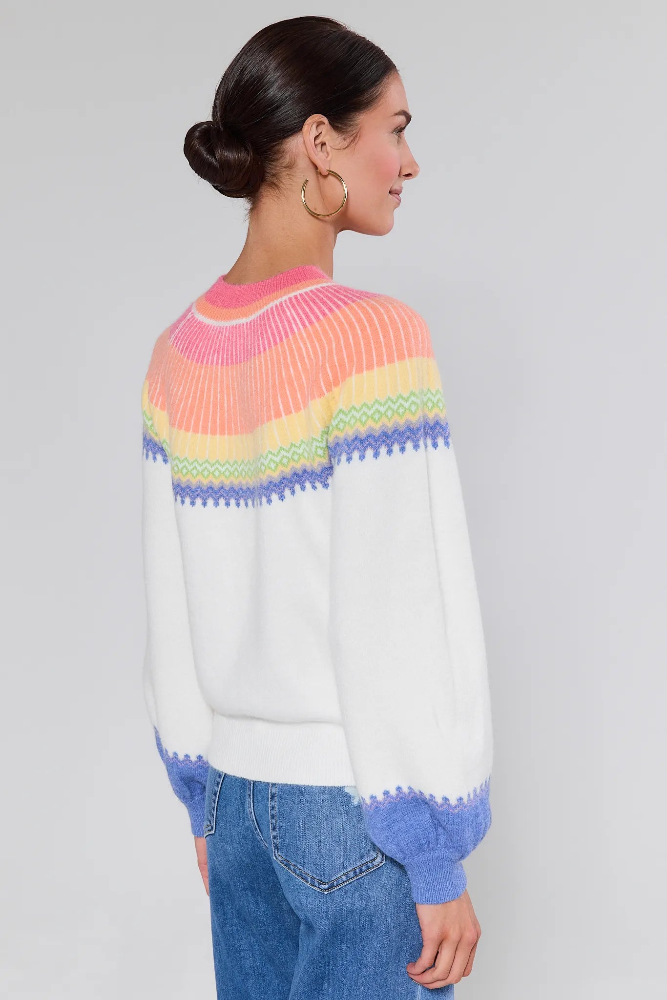 Woman wearing a Kate Multi Color Fair Isle Sweater with a plain background