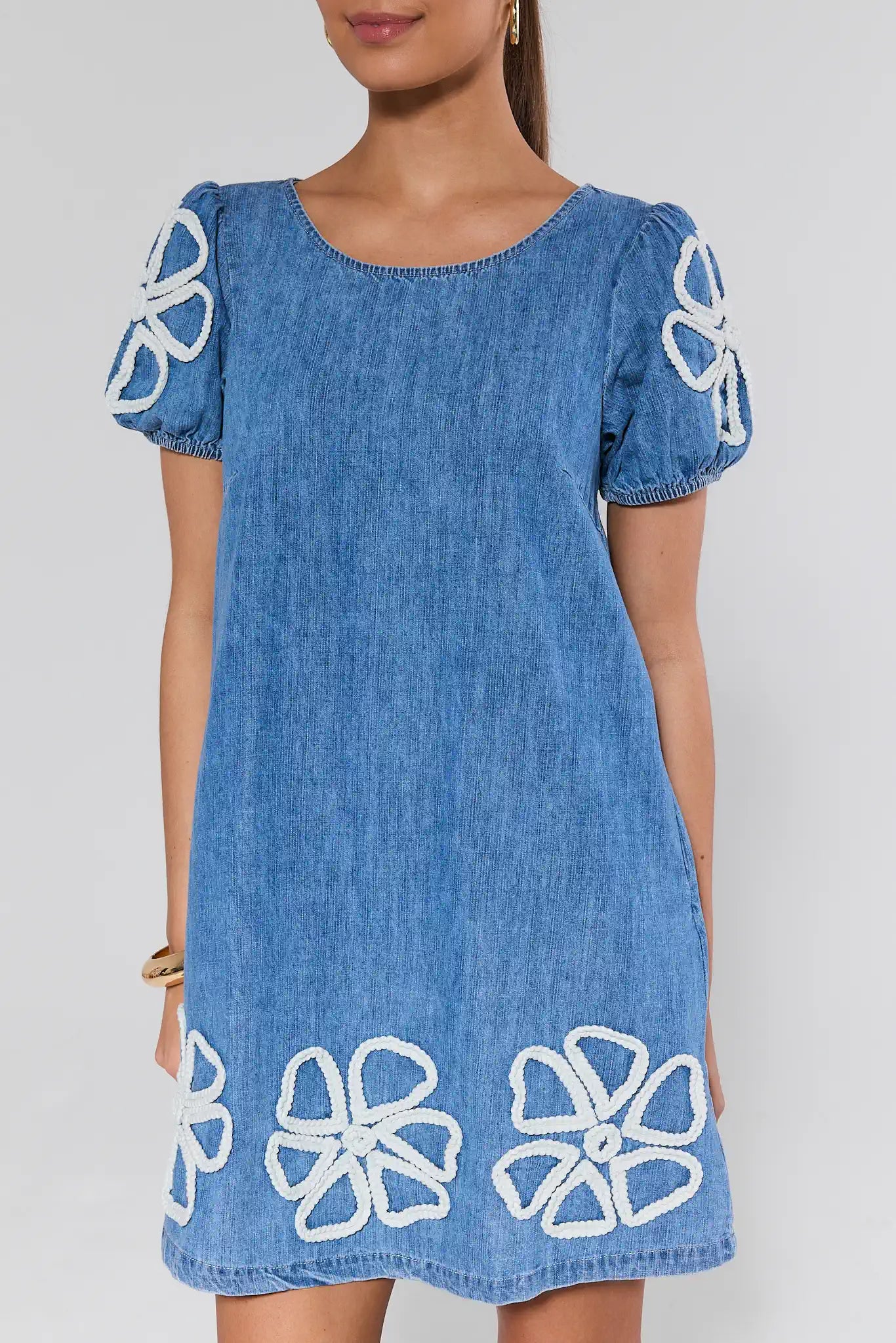 Blue dress with white floral patterns on a plain background