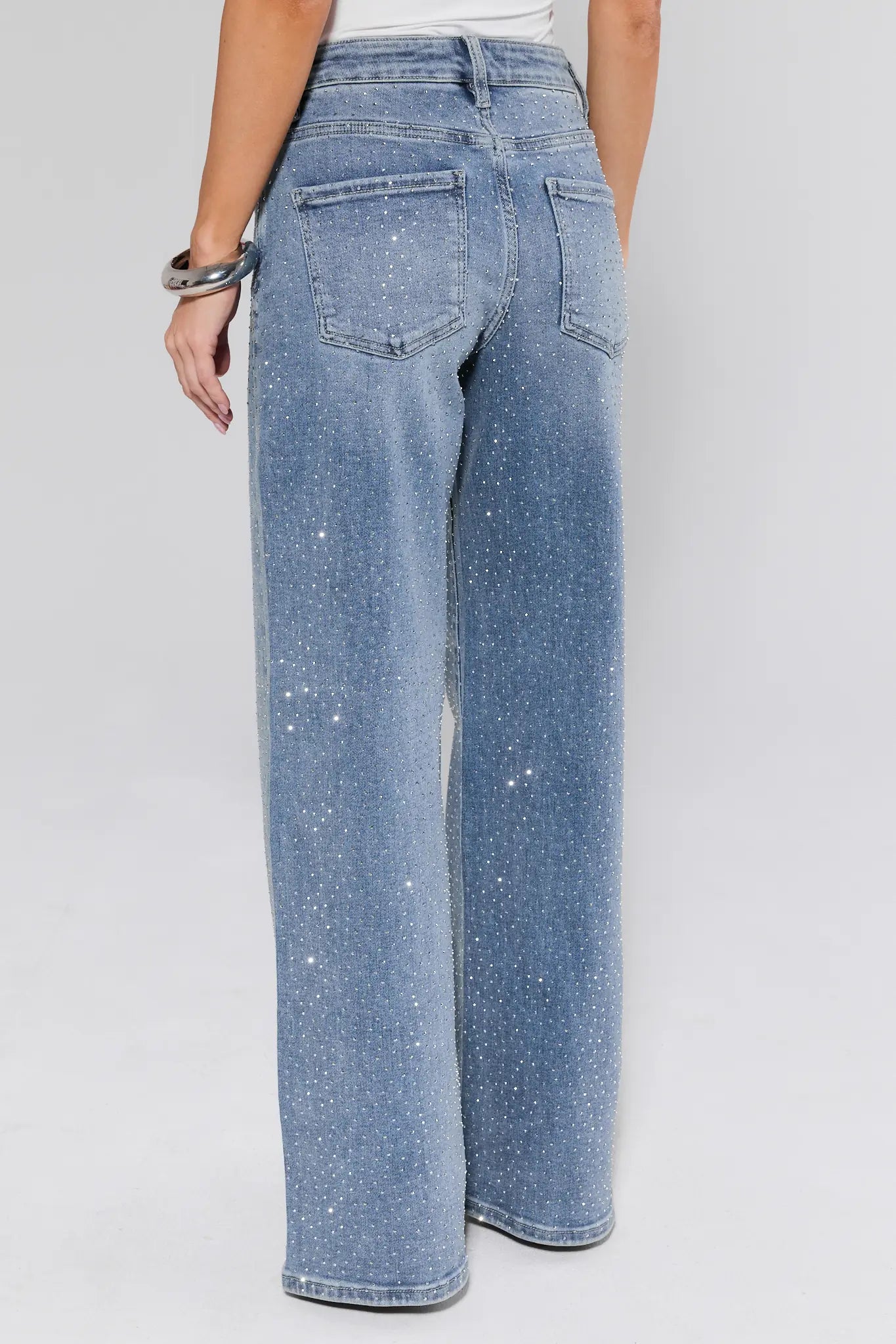 Blue jeans worn by a person on a white background