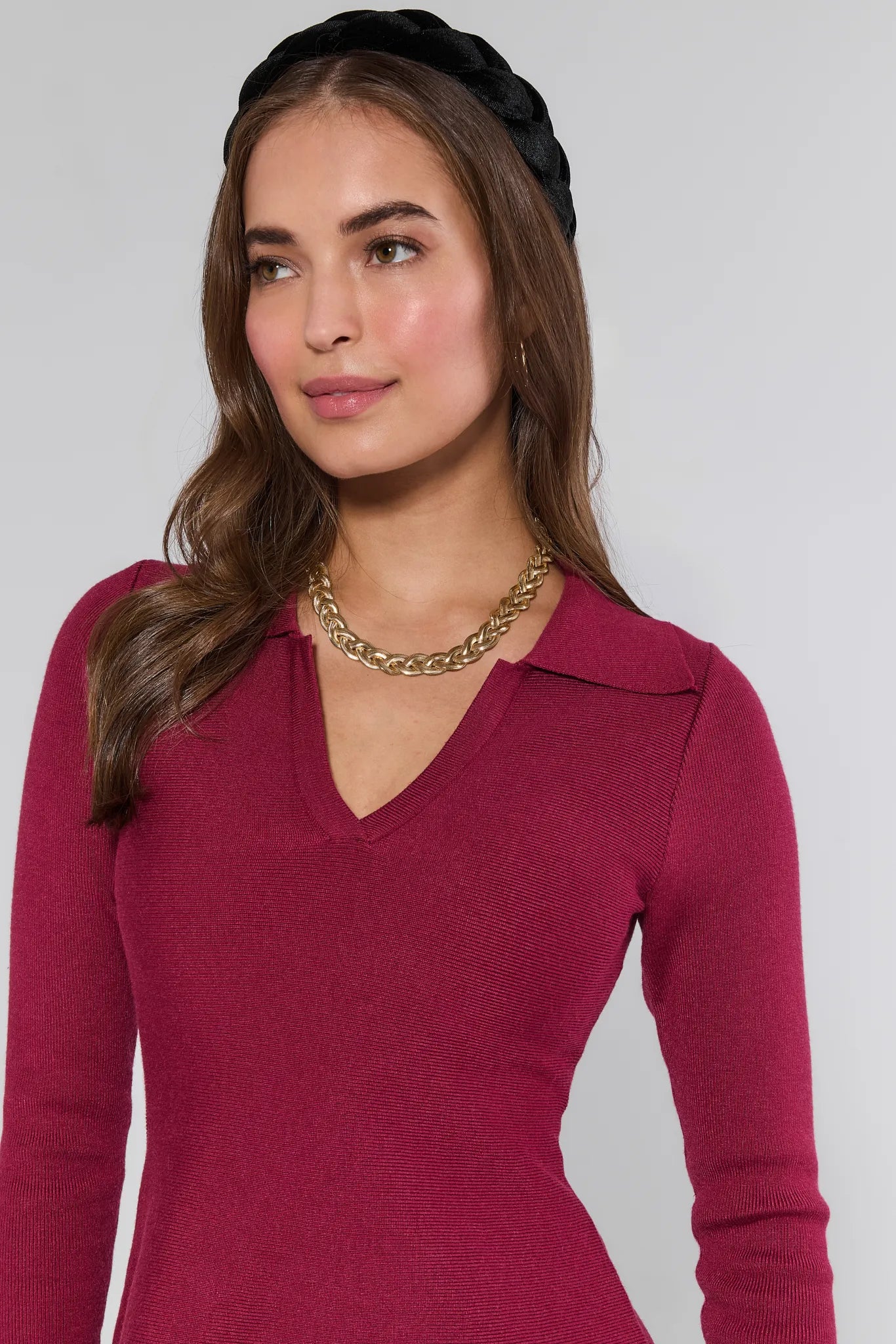Woman wearing a Amelia Dress Burgundy with a plain background