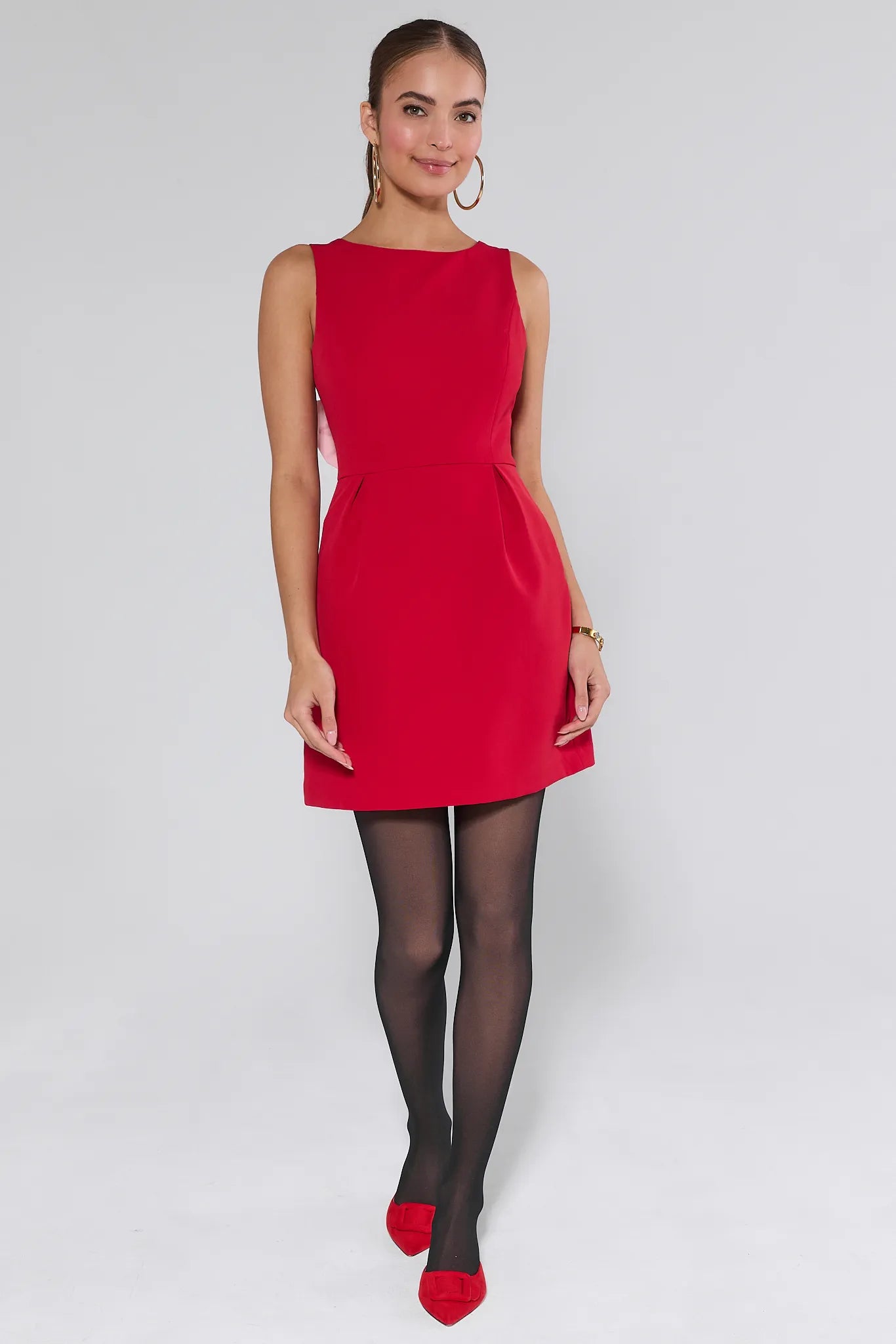 Woman wearing a red Nina dress against a plain background