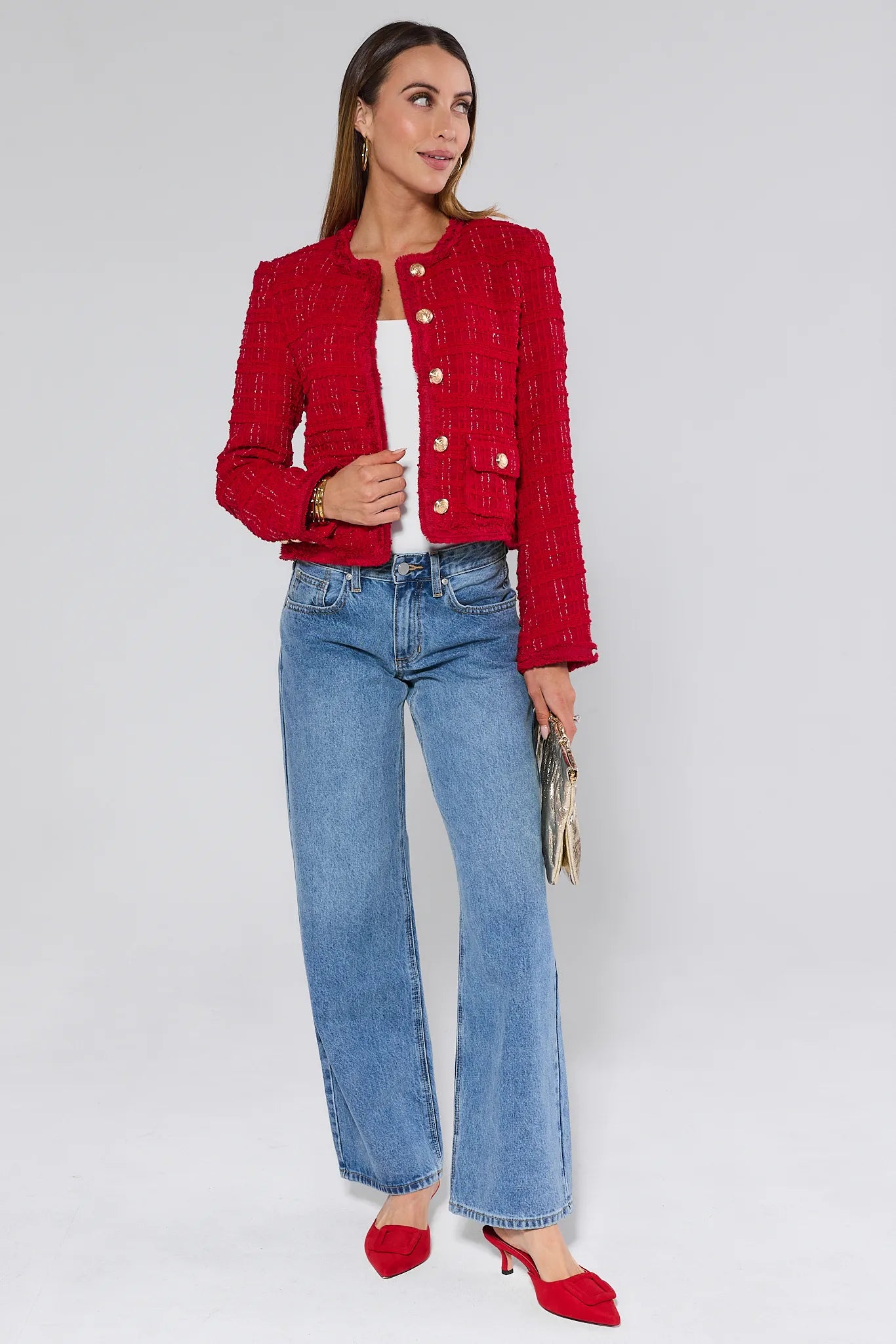 Woman wearing a Evelyn Red Tweed Jacket with gold buttons on a plain background