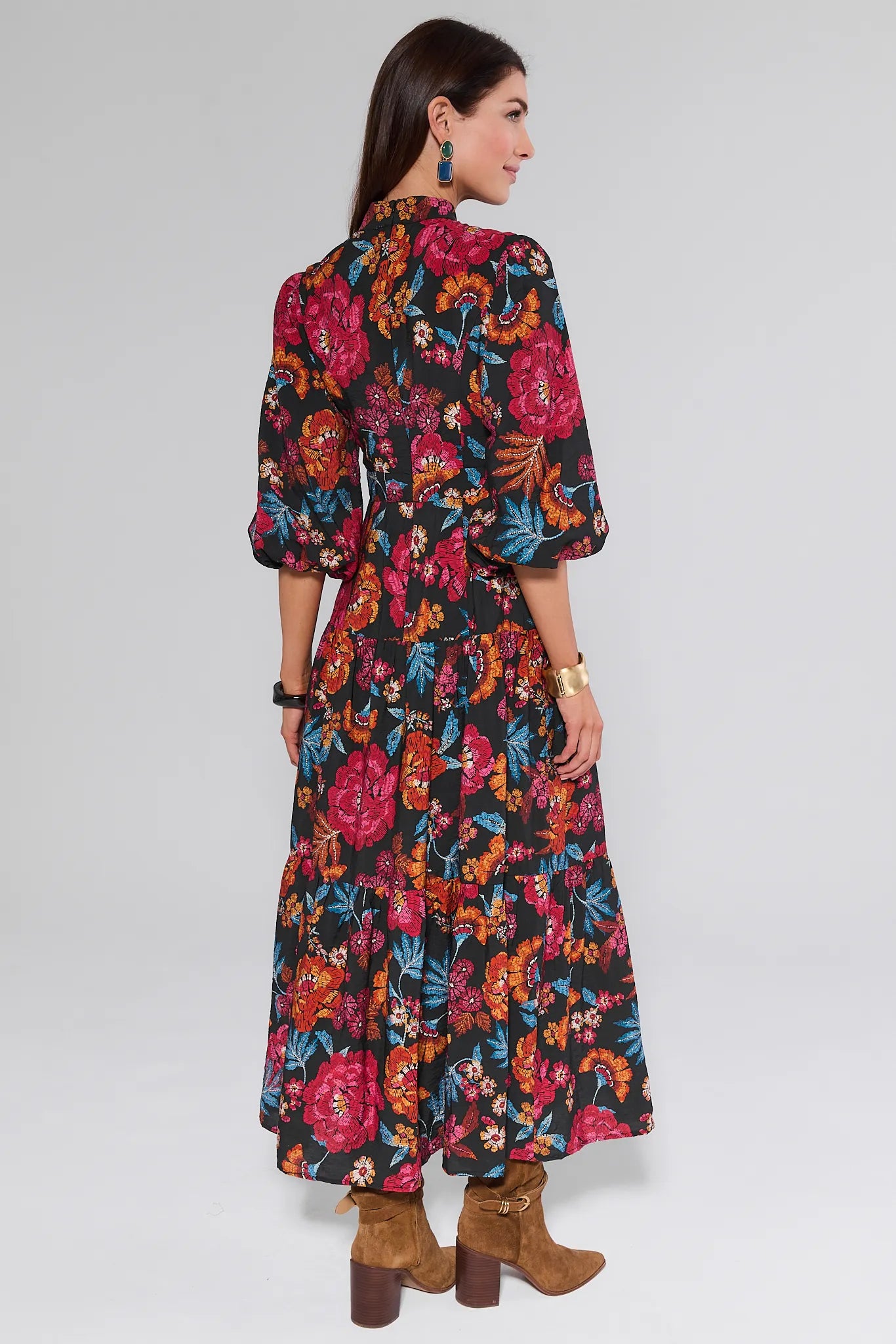 Woman wearing a colorful floral Desi Dress on a white background