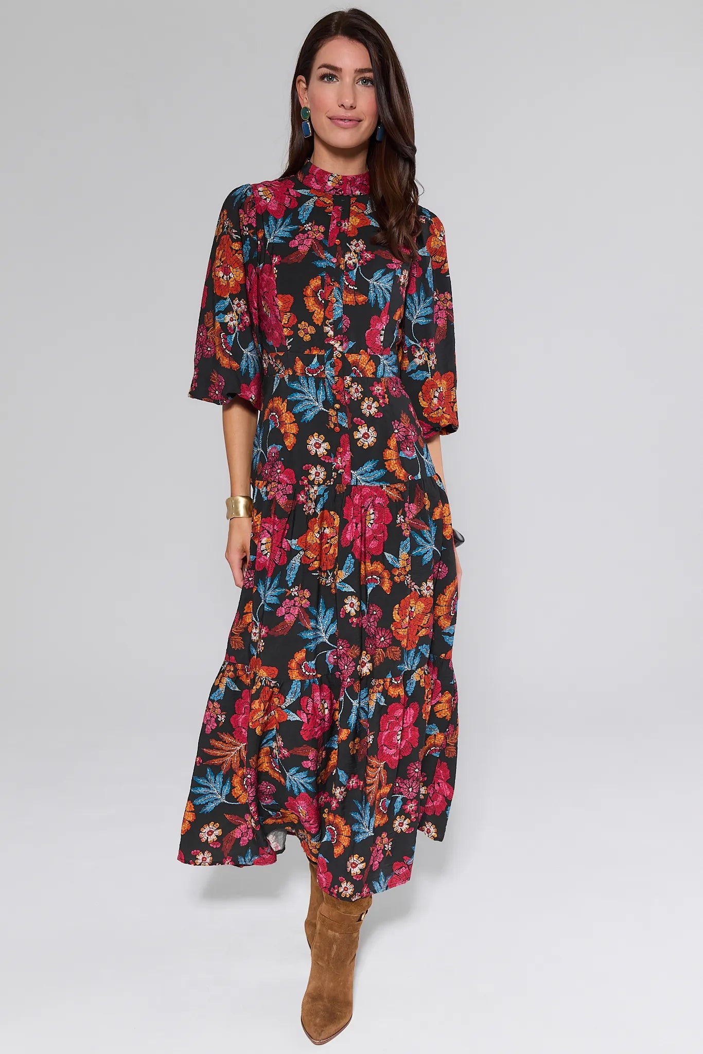 Woman wearing a colorful floral Desi Dress on a white background