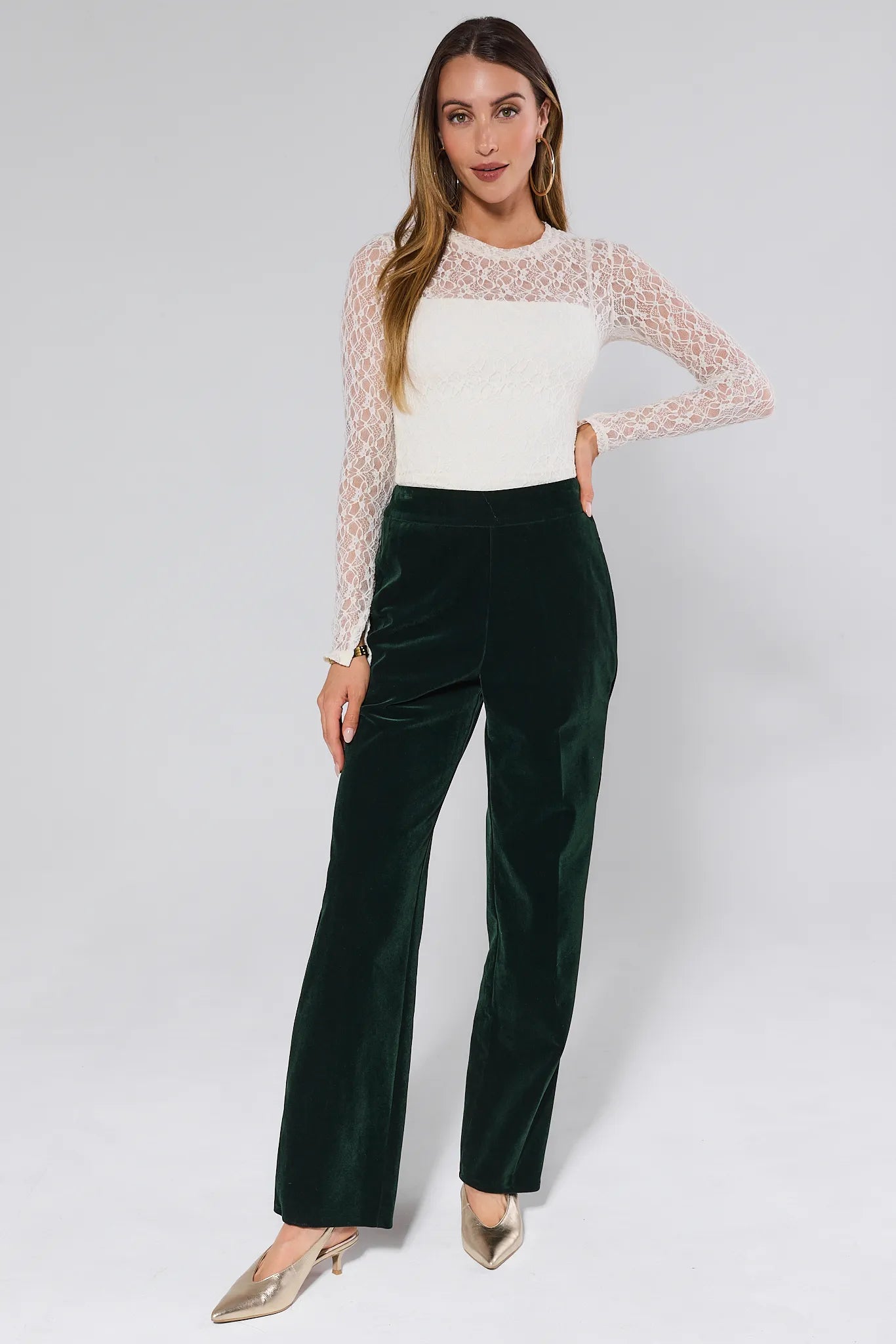 Green Evie Green Velvet Pants worn by a person on a white background