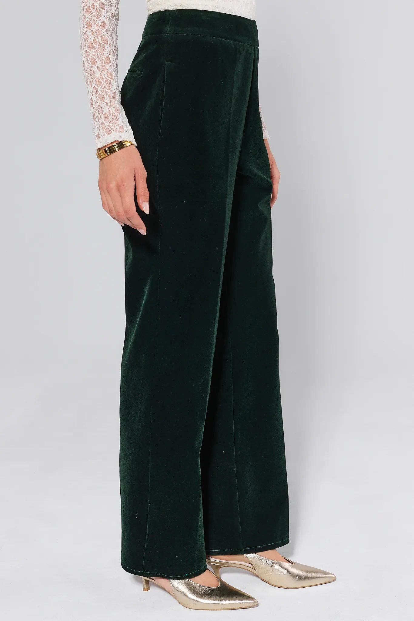 Green Evie Green Velvet Pants worn by a person on a white background